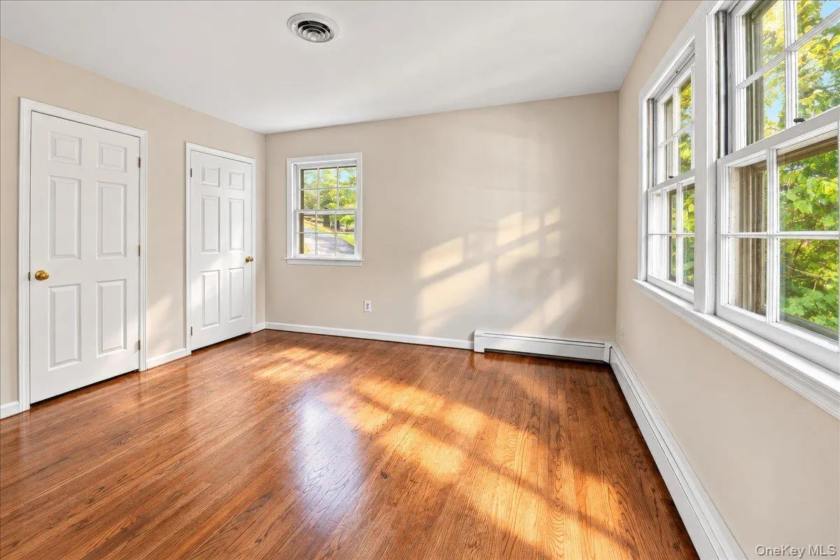 Bright and inviting primary bedroom featuring convenient bathroom access and two matching closets for ample storage. Bright and inviting primary bedroom featuring convenient bathroom access and two matching closets for ample storage.