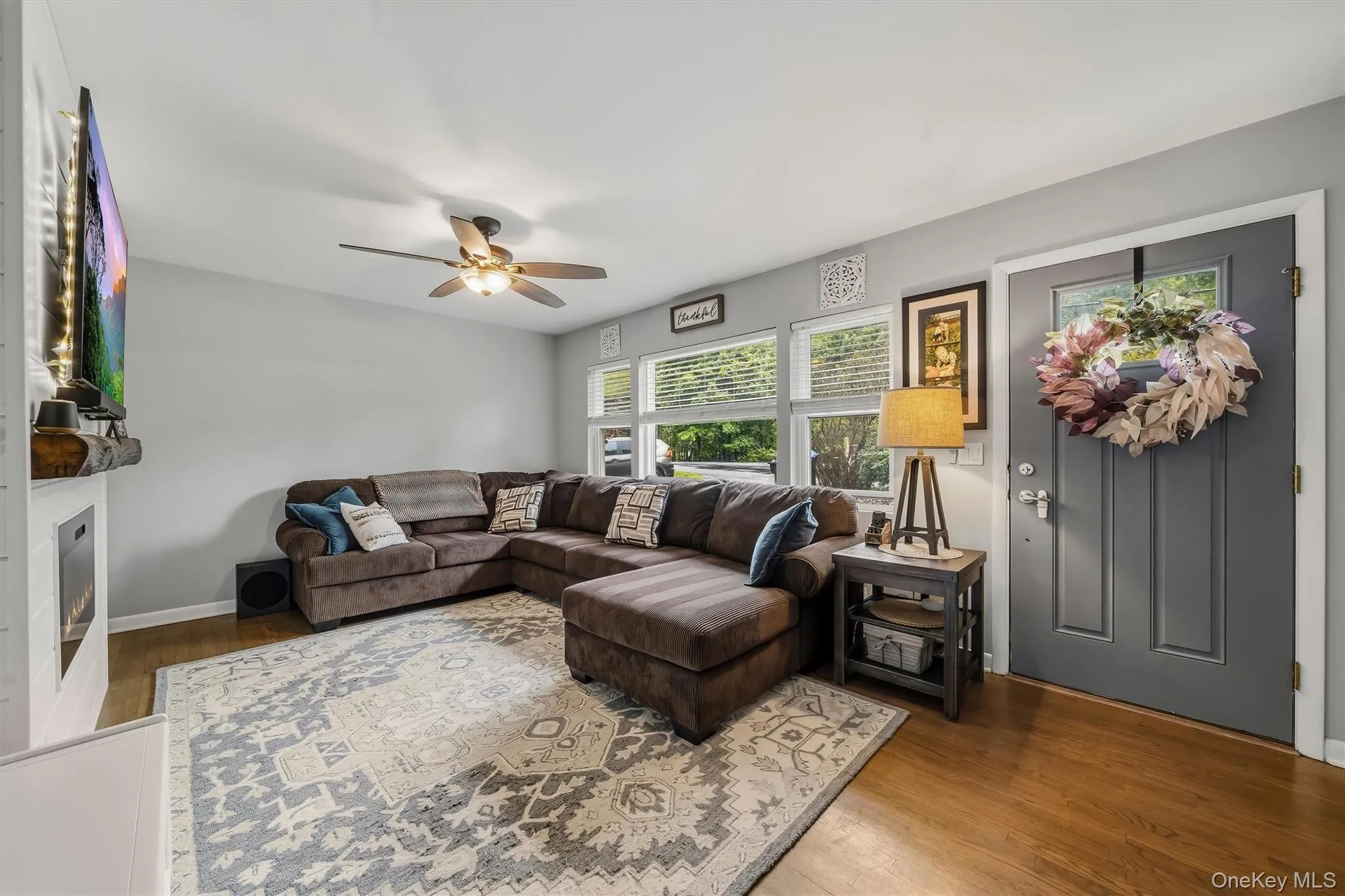 Wood-finish flooring throughout, complemented by a ceiling fan with integrated lighting Wood-finish flooring throughout, complemented by a ceiling fan with integrated lighting