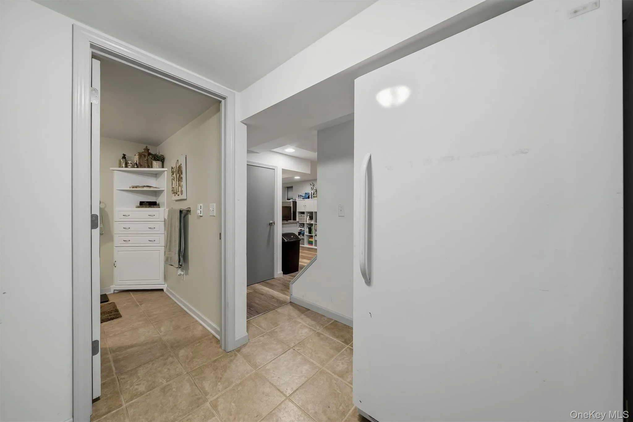 Tile flooring, recessed lighting, white built-in shelving Tile flooring, recessed lighting, white built-in shelving