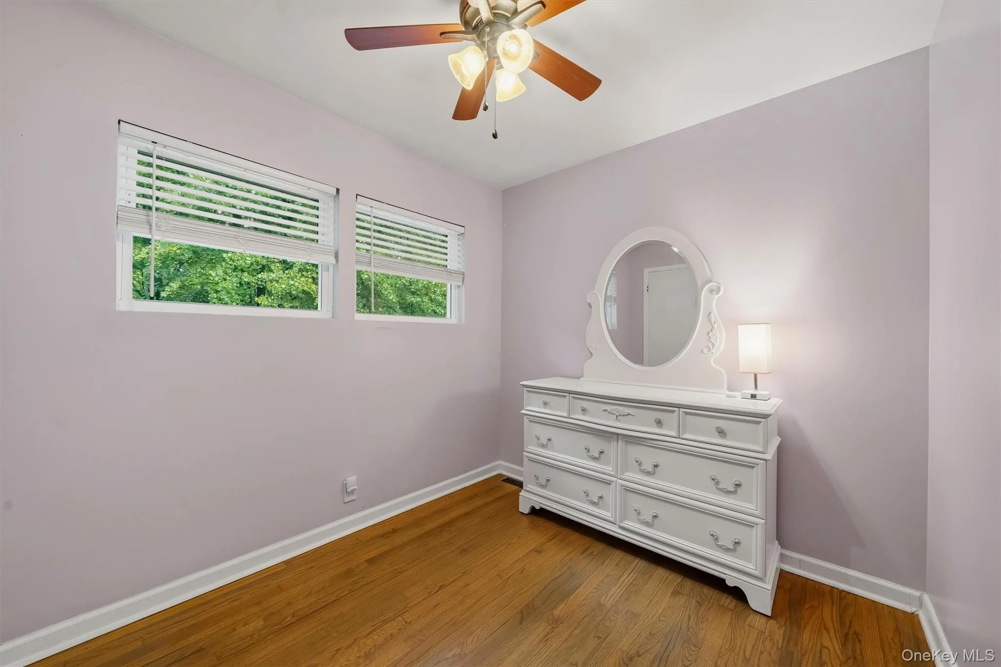 Hardwood flooring, dual windows with blinds, ceiling fan with integrated lighting, and crown molding Hardwood flooring, dual windows with blinds, ceiling fan with integrated lighting, and crown molding