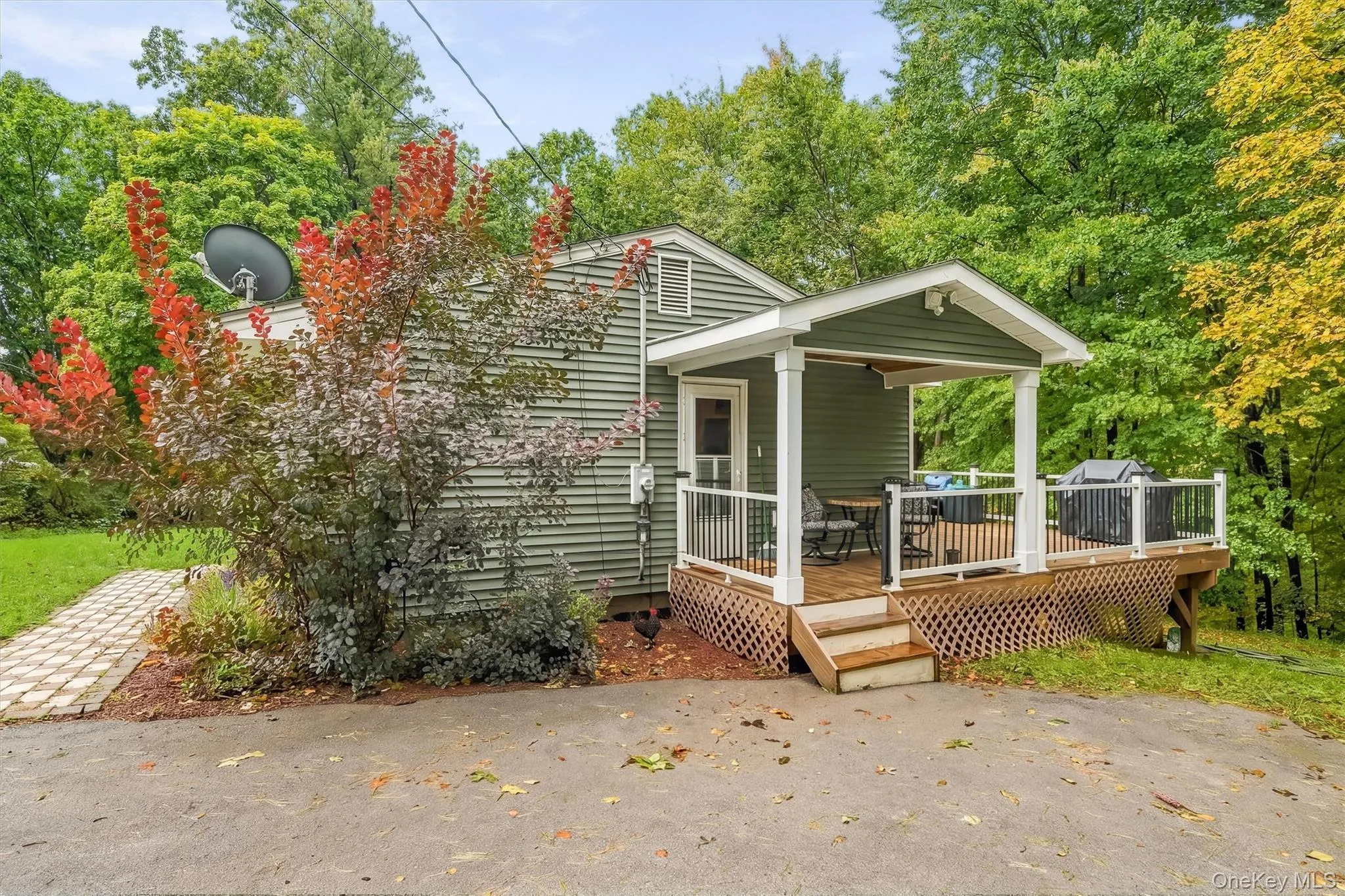 Wood deck featuring a covered porch, white railings, and direct exterior access Wood deck featuring a covered porch, white railings, and direct exterior access
