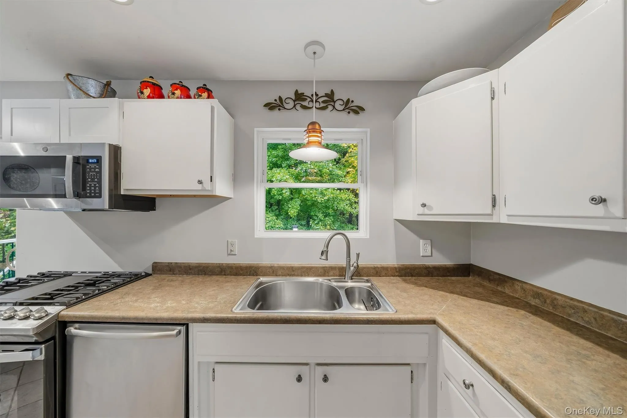 White cabinetry with metal hardware White cabinetry with metal hardware