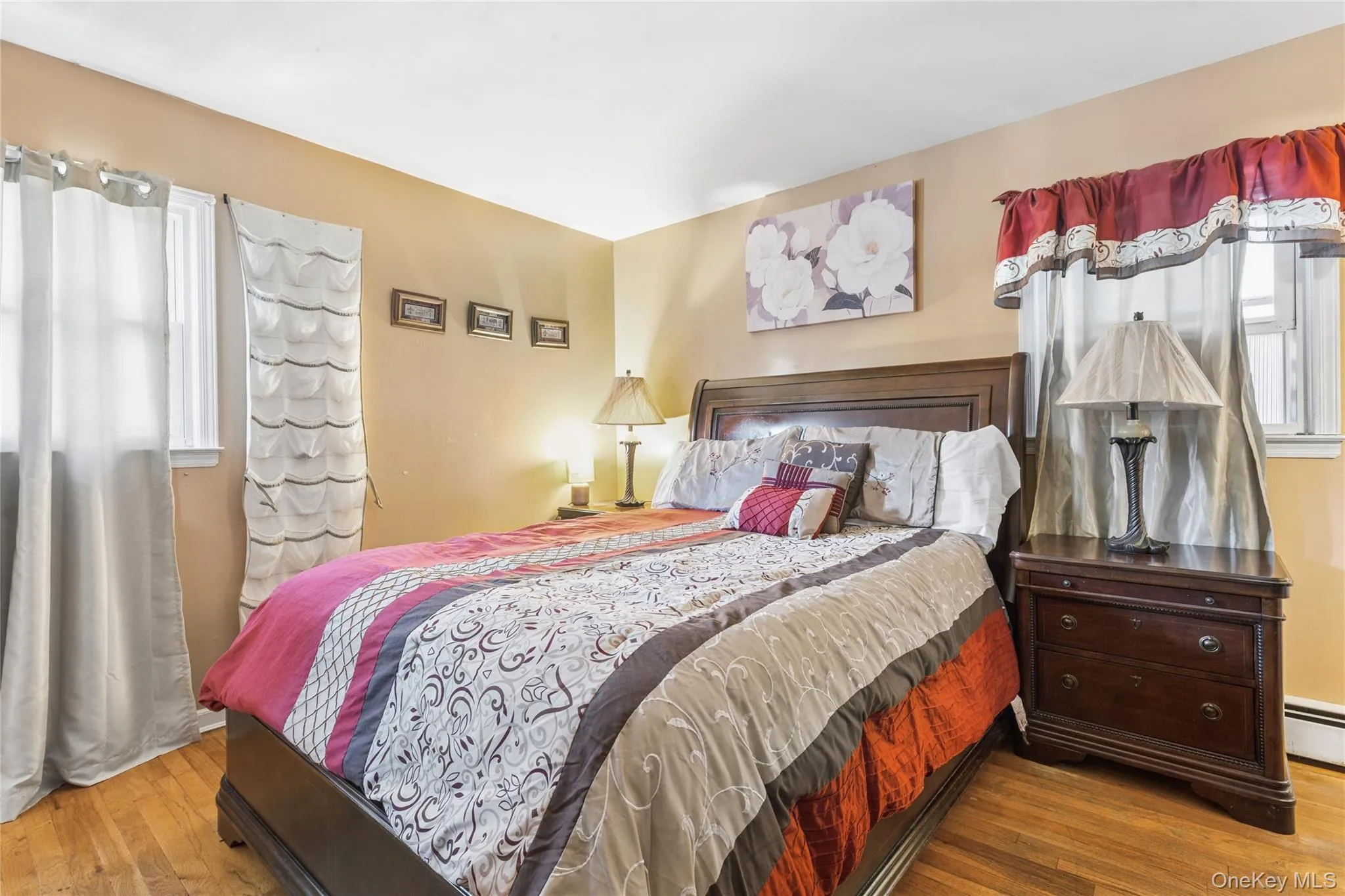 Hardwood flooring, painted walls, windows with trim, and lighting fixture Hardwood flooring, painted walls, windows with trim, and lighting fixture