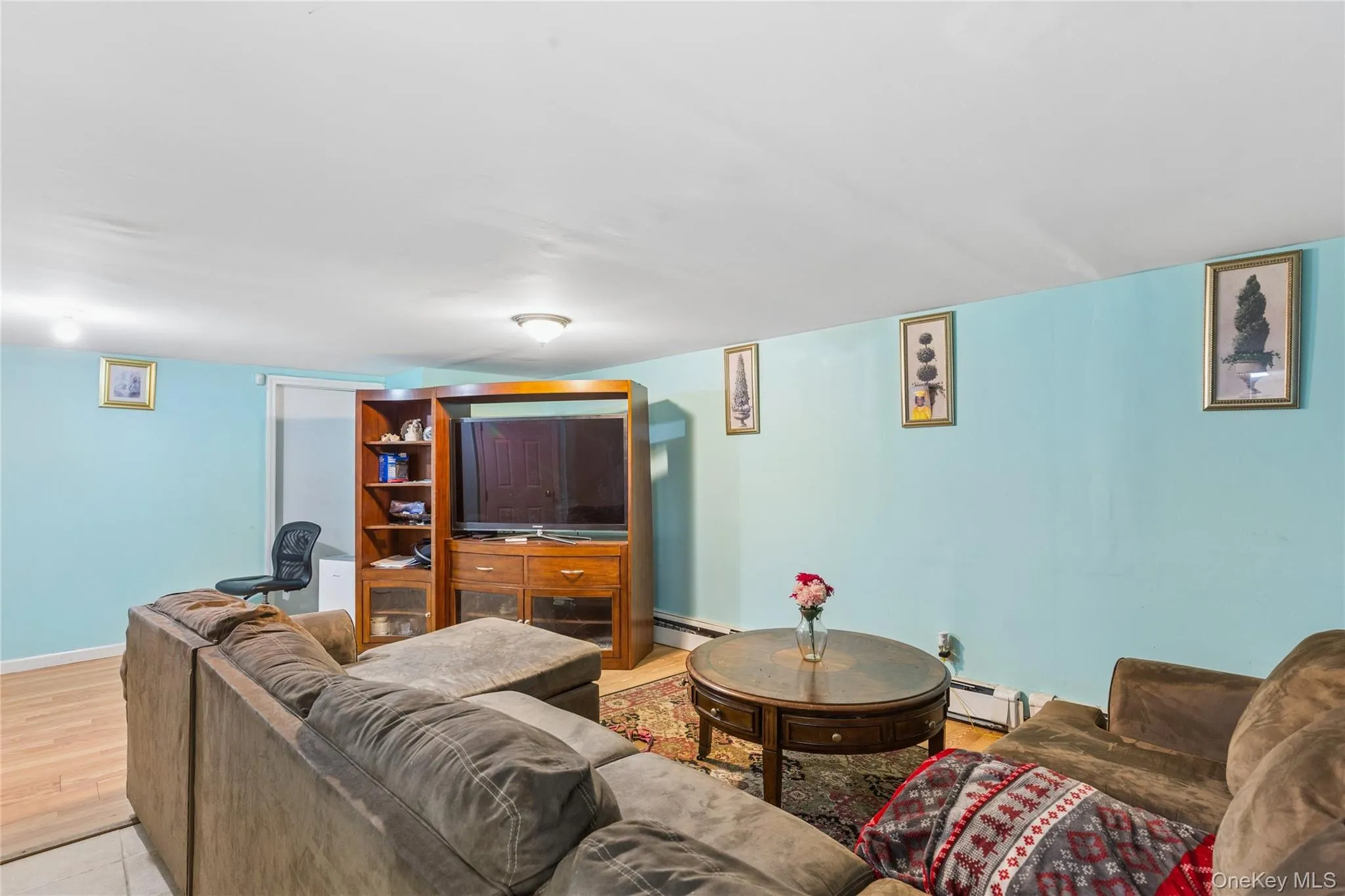 Recessed lighting illuminates the room with light blue wall finishes and wood-finish flooring Recessed lighting illuminates the room with light blue wall finishes and wood-finish flooring