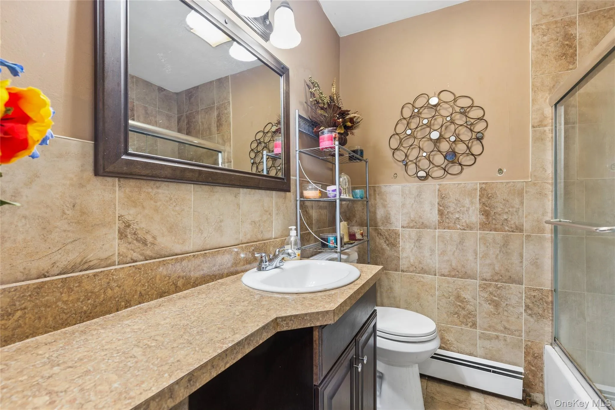 Full vanity with an integrated sink, broad countertop, framed wall mirror, and vanity lighting Full vanity with an integrated sink, broad countertop, framed wall mirror, and vanity lighting