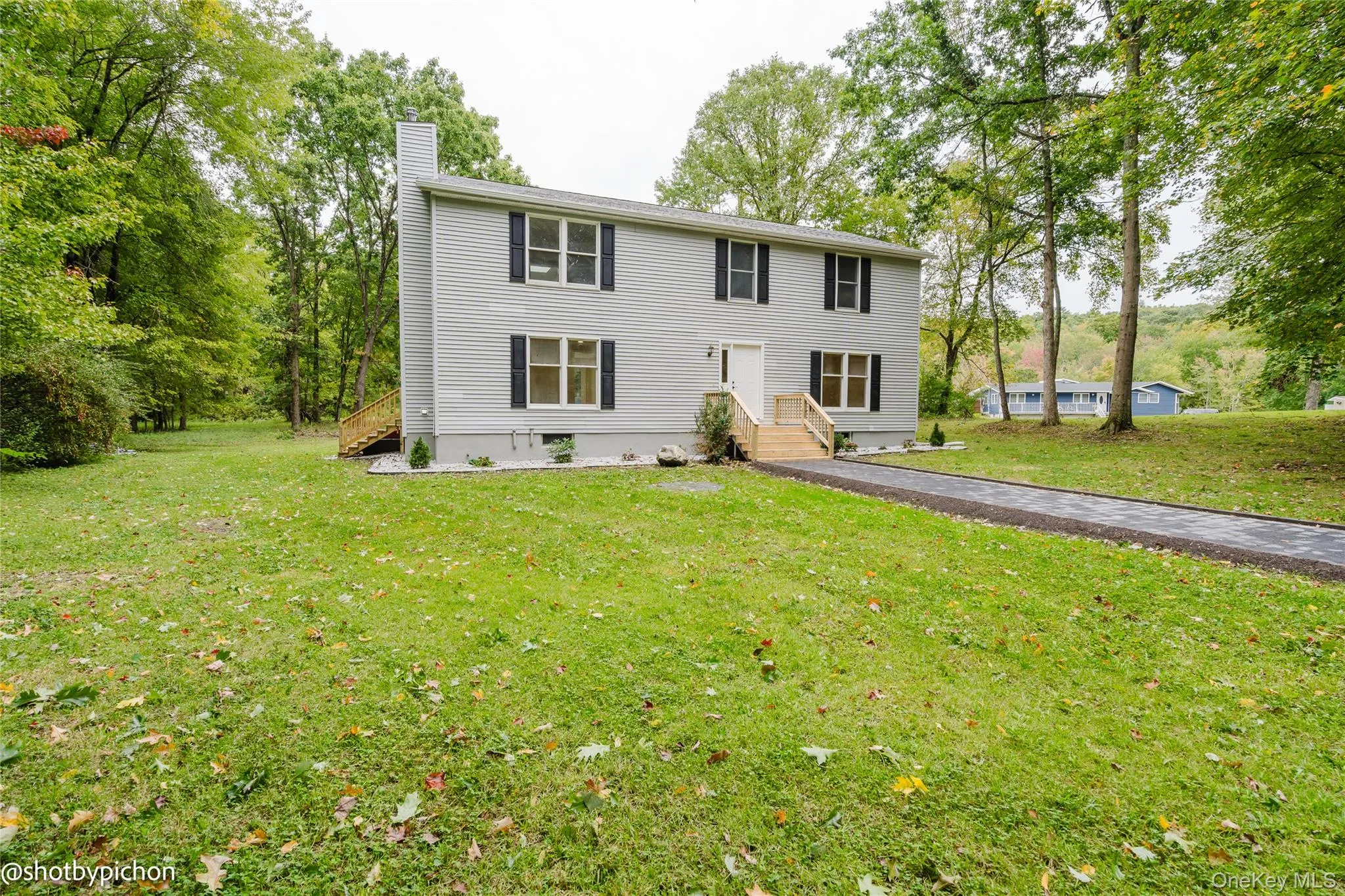 Gray siding exterior with black window shutters Gray siding exterior with black window shutters