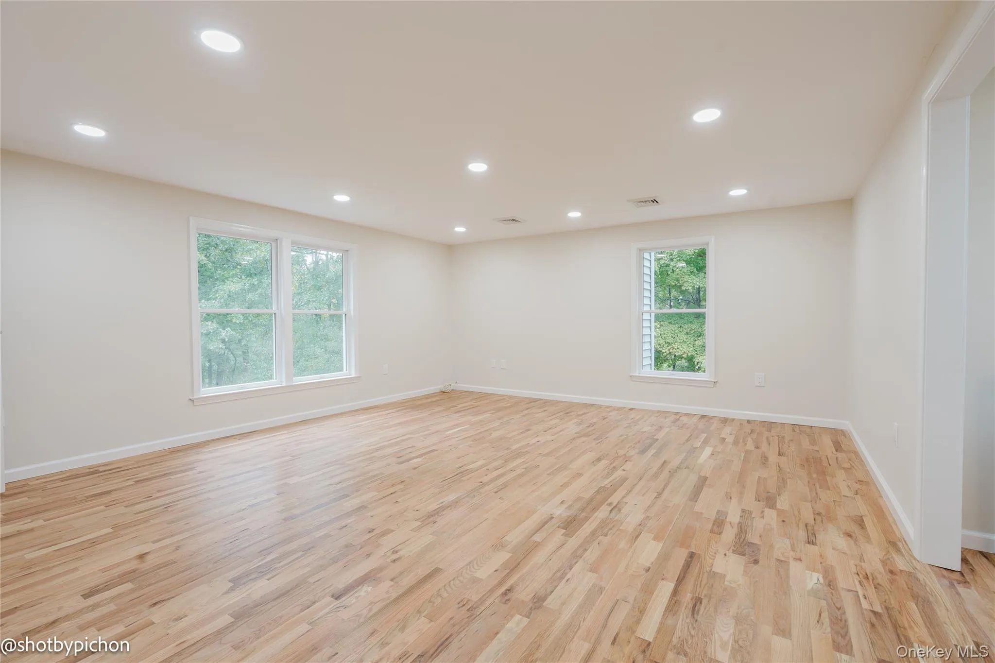 Recessed lighting illuminates wood-finish flooring Recessed lighting illuminates wood-finish flooring