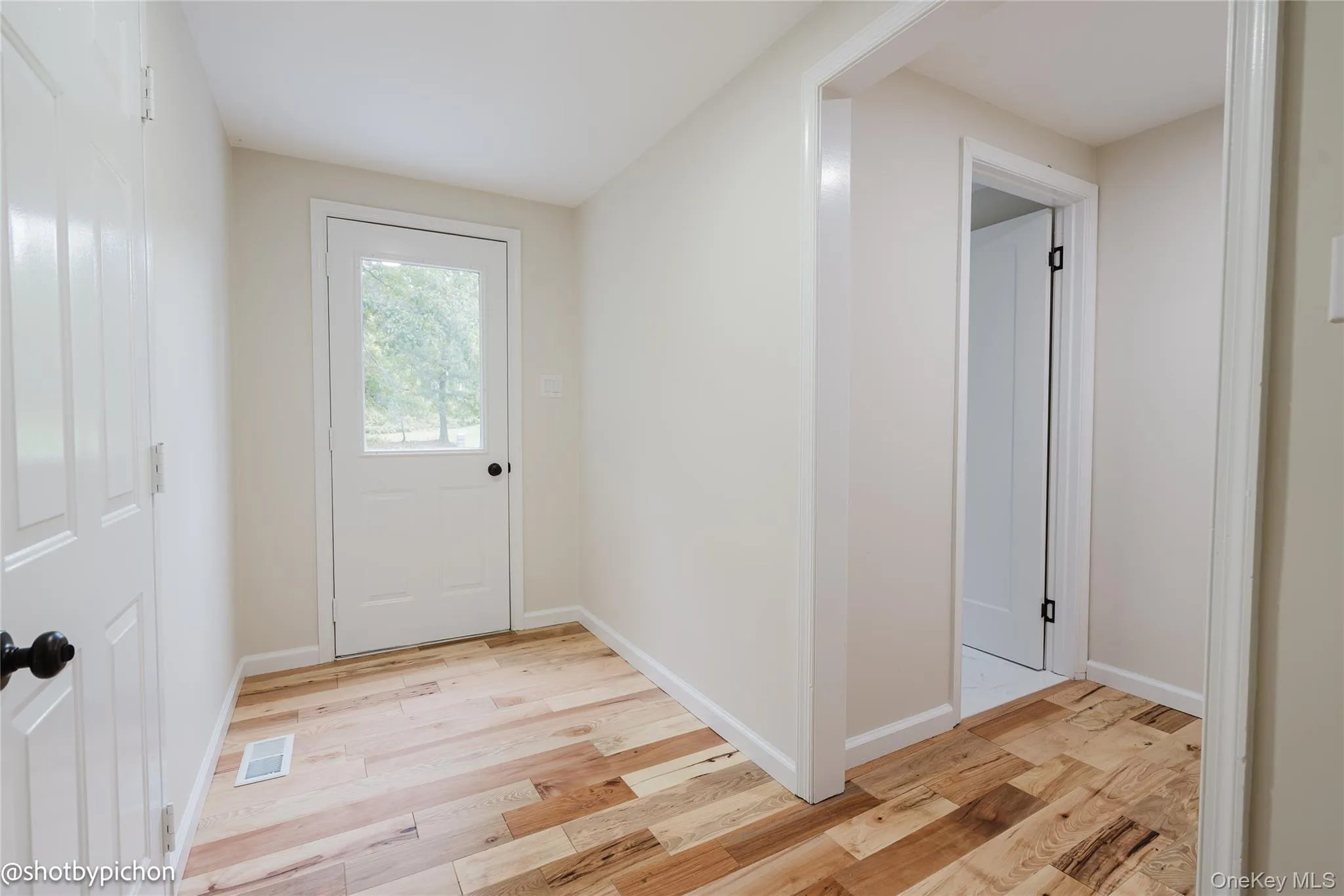 Wood-finish flooring throughout, white interior doors, and neutral wall paint Wood-finish flooring throughout, white interior doors, and neutral wall paint