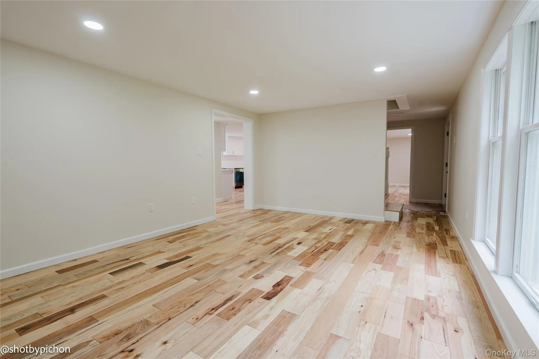 Recessed lighting, wood-finish flooring, white trim, and multiple windows Recessed lighting, wood-finish flooring, white trim, and multiple windows