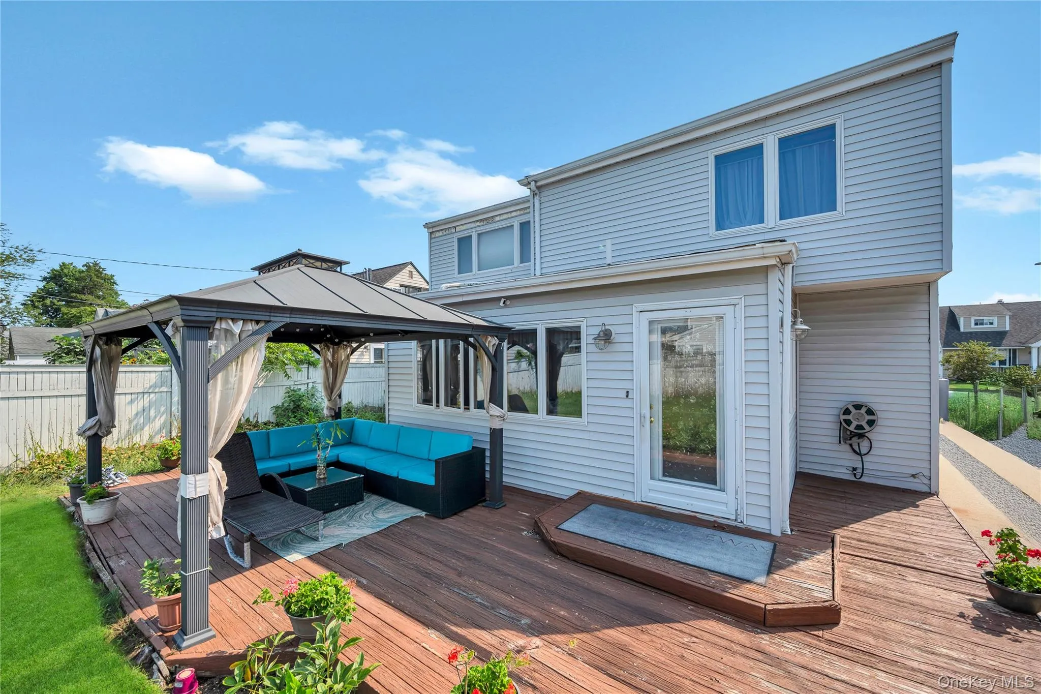 Wooden terrace featuring an outdoor hangout area and a gazebo Wooden terrace featuring an outdoor hangout area and a gazebo