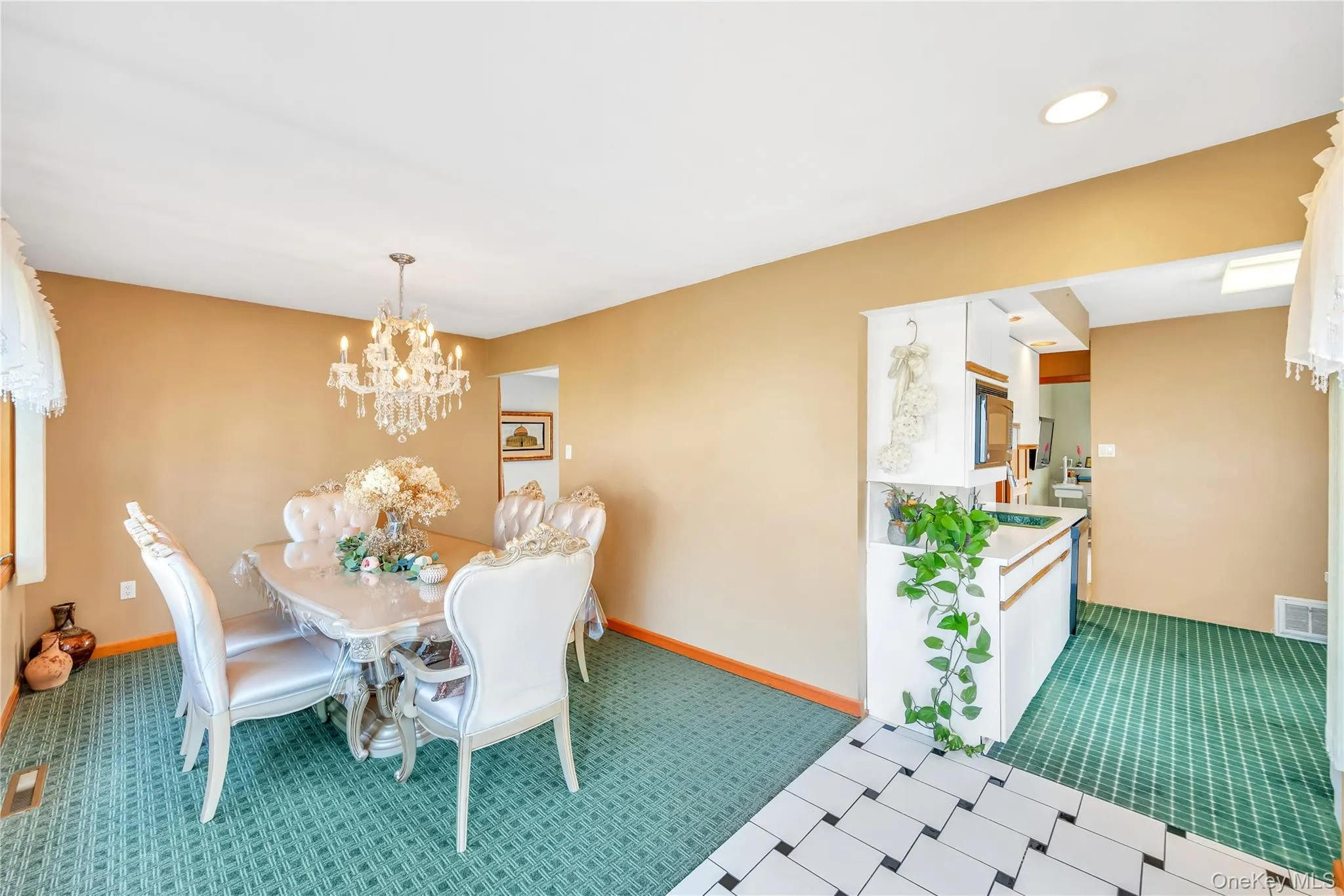 Carpeted dining area featuring a chandelier and recessed lighting Carpeted dining area featuring a chandelier and recessed lighting