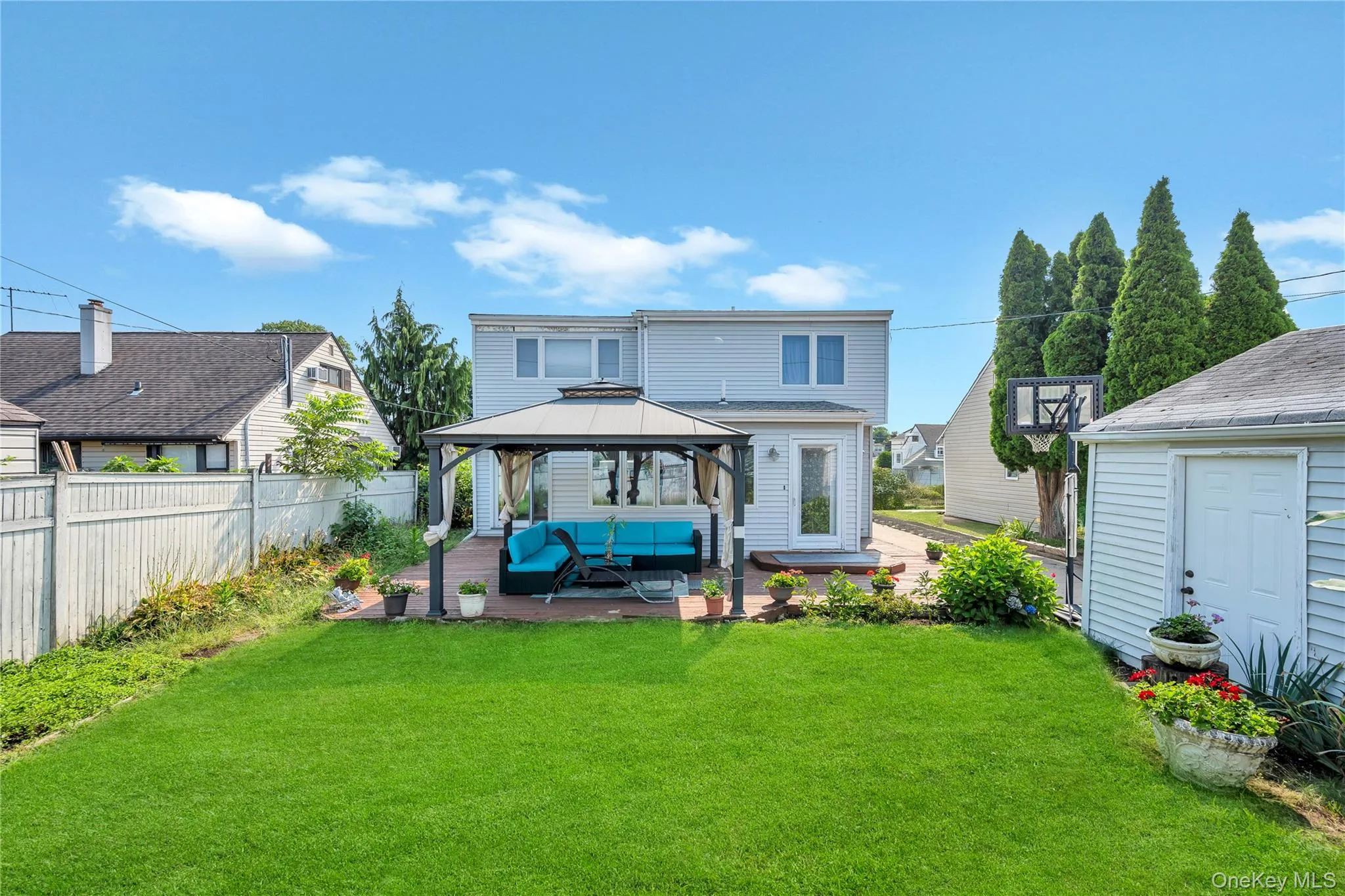 Rear view of property with a patio area, a gazebo, and an outdoor living space Rear view of property with a patio area, a gazebo, and an outdoor living space