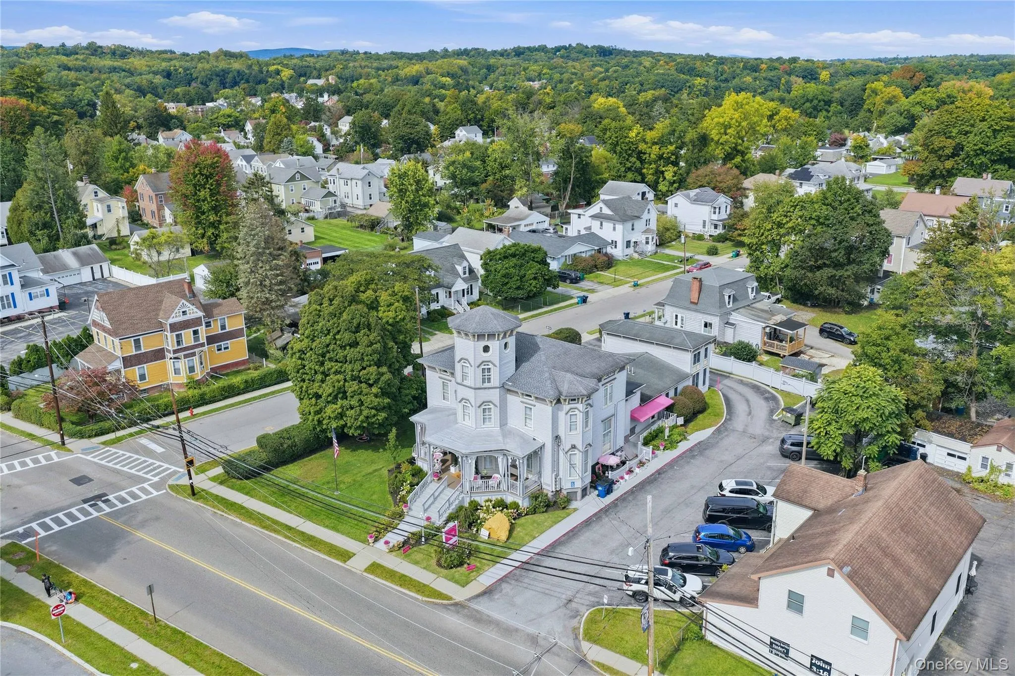 Victorian-style architecture featuring a prominent turret, wraparound porch, and detailed exterior trim Victorian-style architecture featuring a prominent turret, wraparound porch, and detailed exterior trim