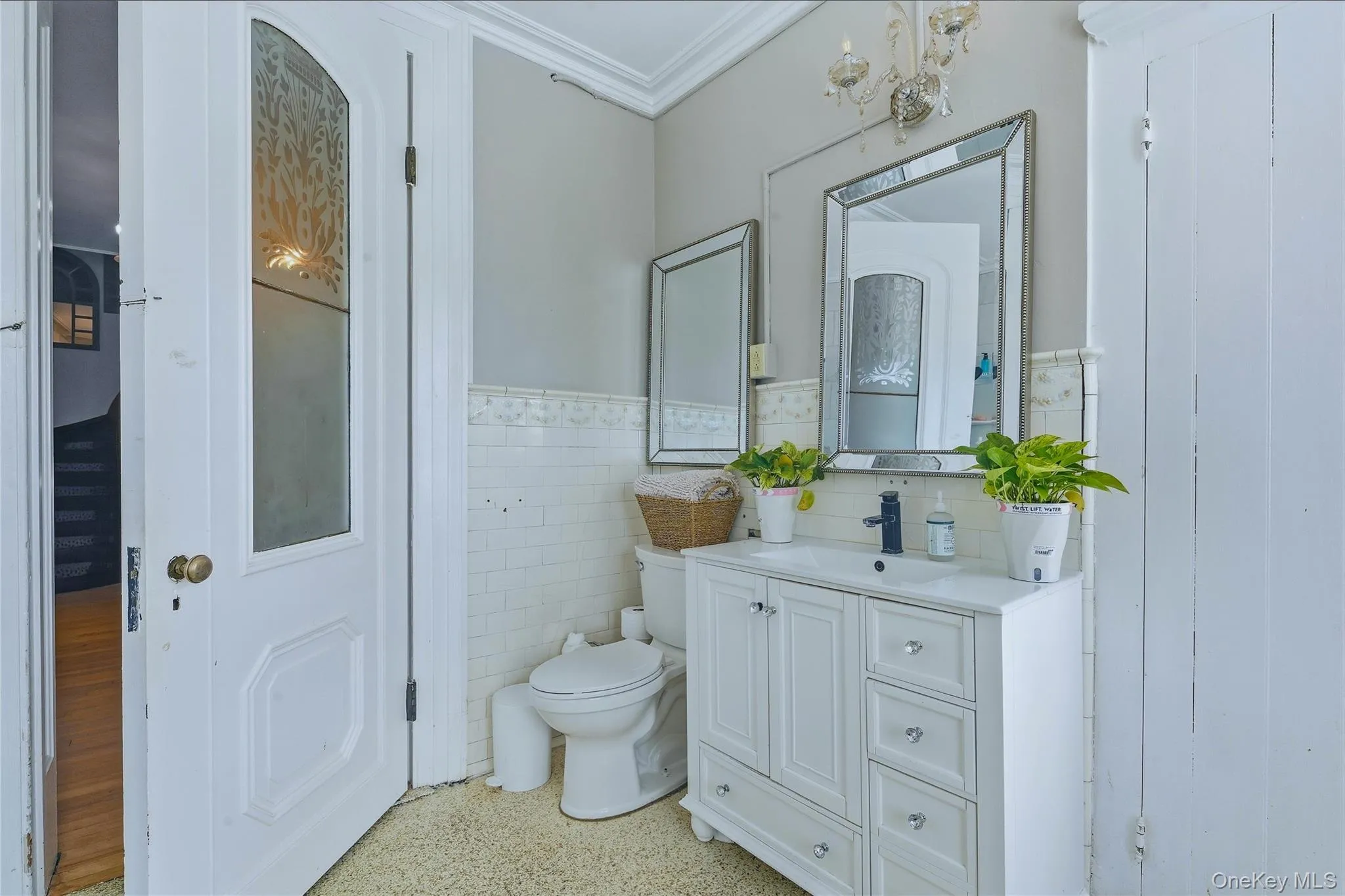 White vanity with integrated sink, black single-handle faucet, and mirrored storage cabinet White vanity with integrated sink, black single-handle faucet, and mirrored storage cabinet