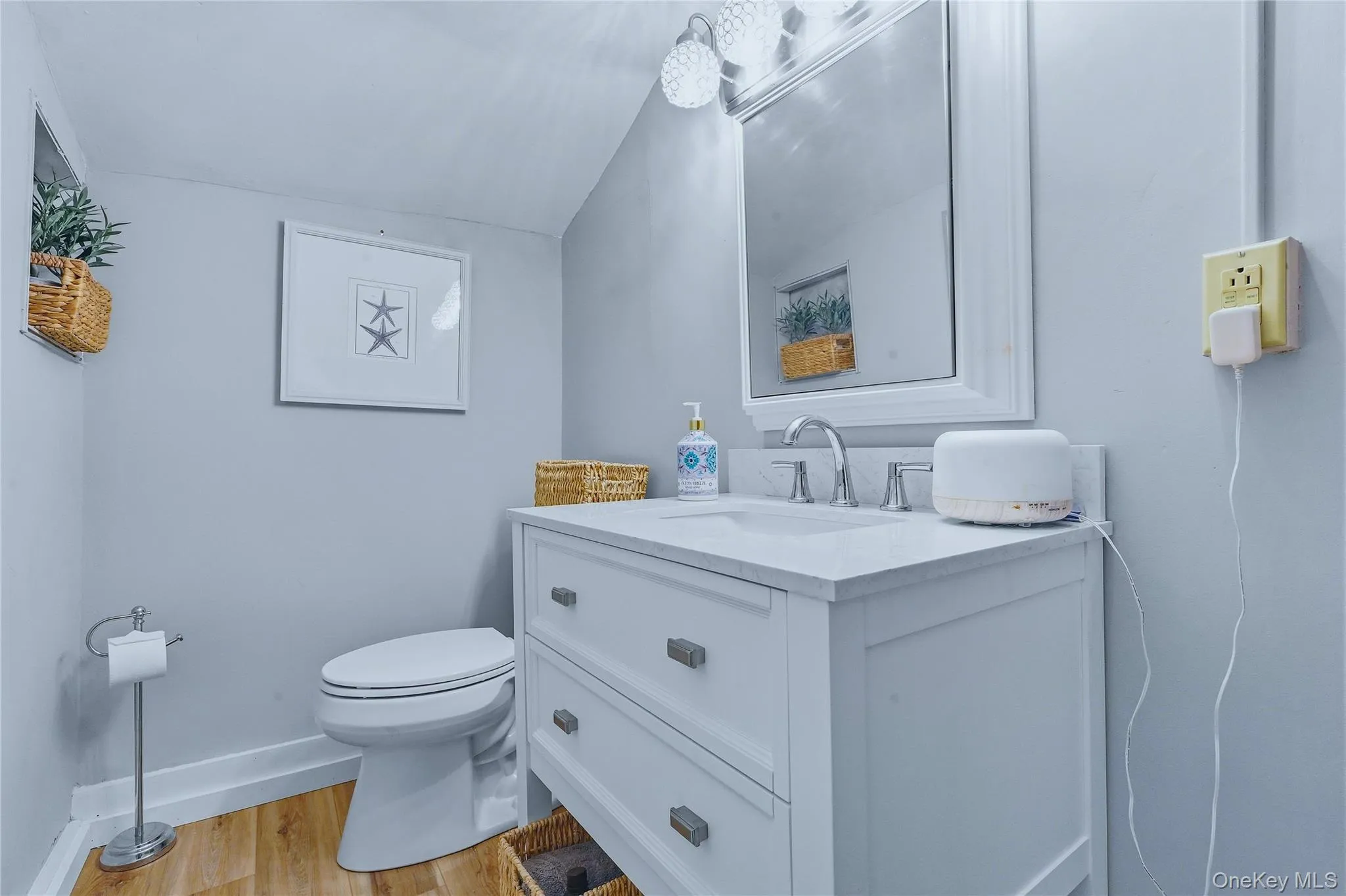 White vanity with a single basin sink, chrome faucet, and integrated countertop White vanity with a single basin sink, chrome faucet, and integrated countertop