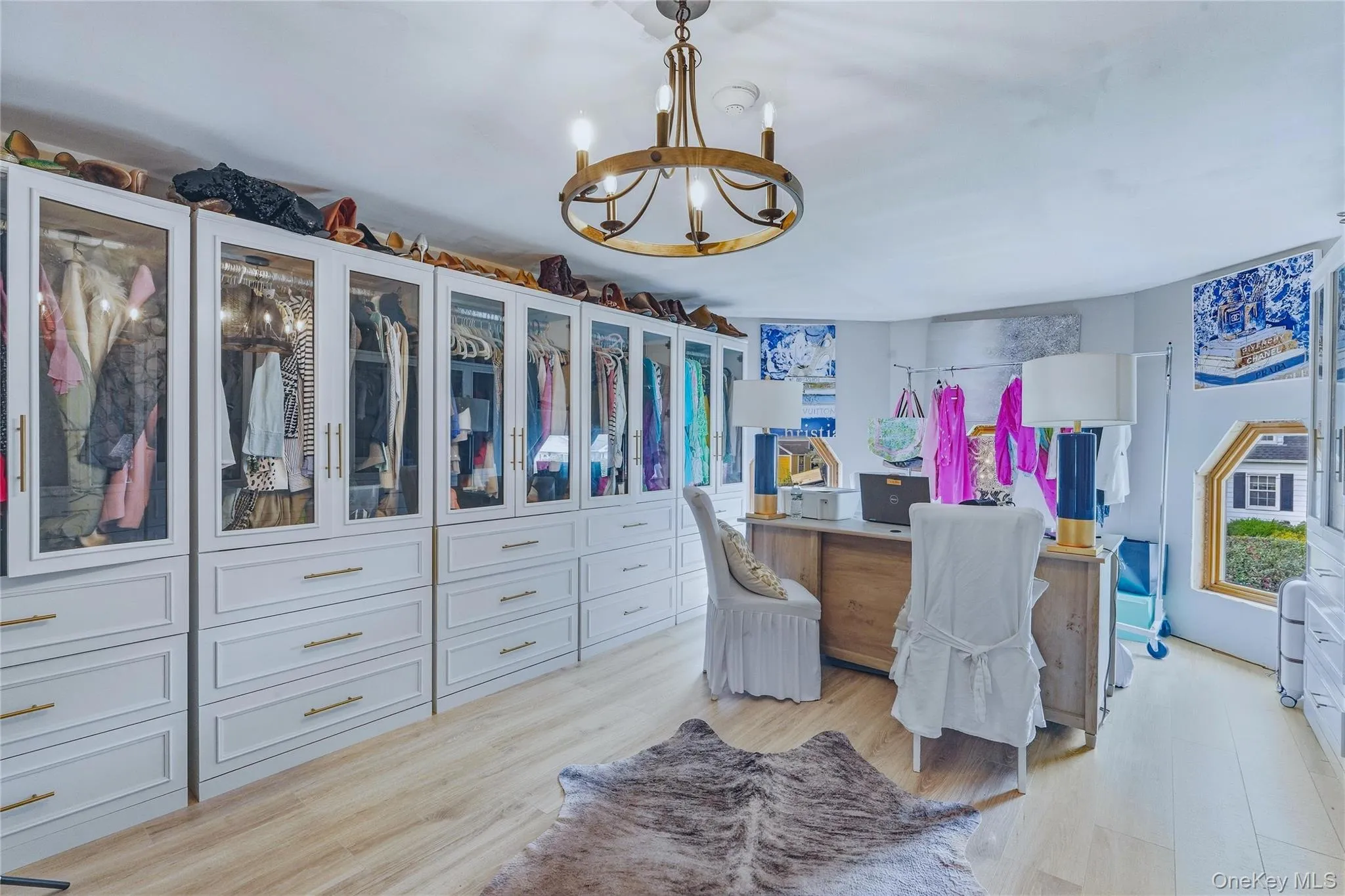 Custom built-in cabinetry with glass-front uppers, brass hardware, and ample drawer storage Custom built-in cabinetry with glass-front uppers, brass hardware, and ample drawer storage