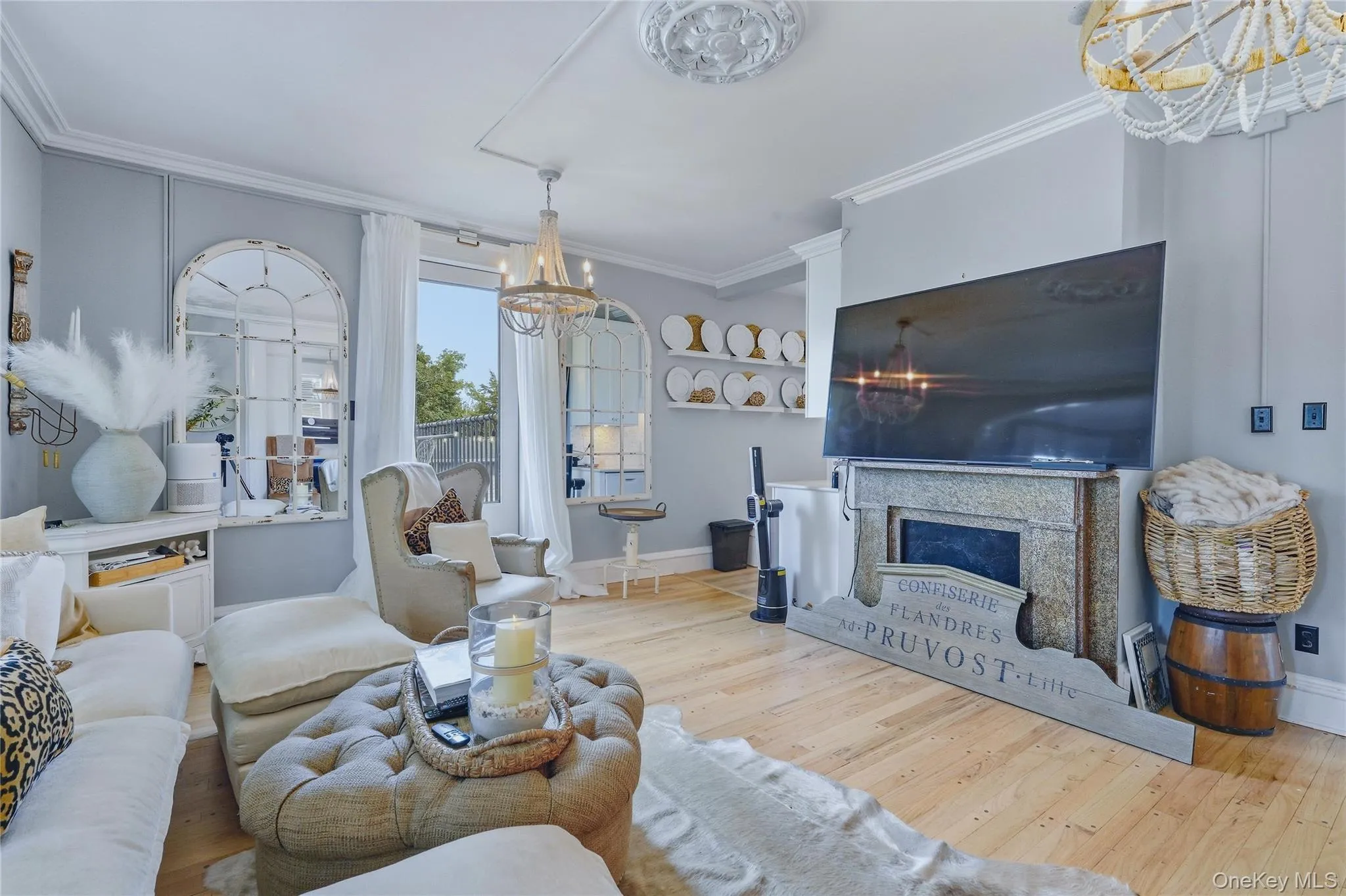 Light wood-finish flooring, decorative ceiling medallion, sliding glass door, stone fireplace surround, and crown molding Light wood-finish flooring, decorative ceiling medallion, sliding glass door, stone fireplace surround, and crown molding