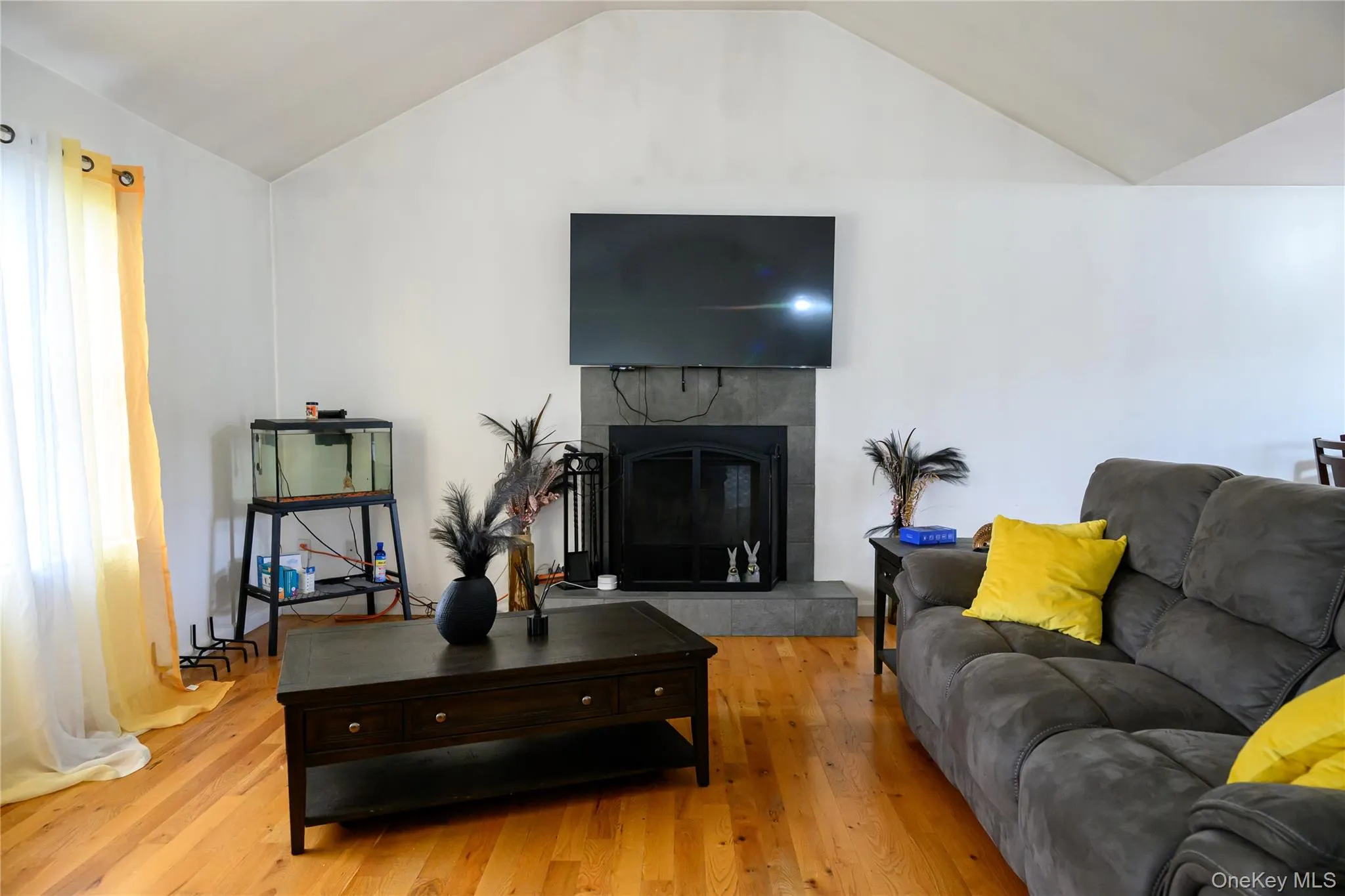 Living room with wood burning fireplace and cathedral ceilings Living room with wood burning fireplace and cathedral ceilings