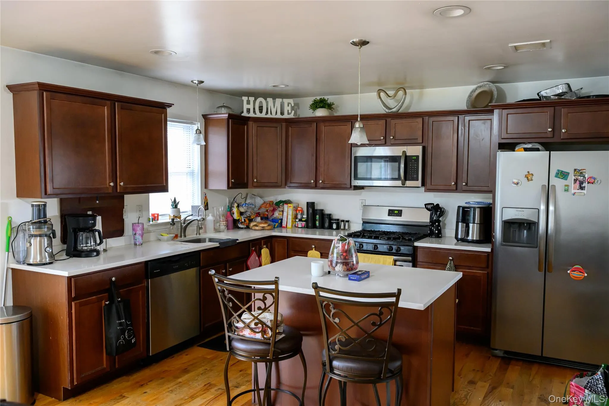 Kitchen wood cabinets, hardwood floors, granite counters and stainless steel appliances Kitchen wood cabinets, hardwood floors, granite counters and stainless steel appliances