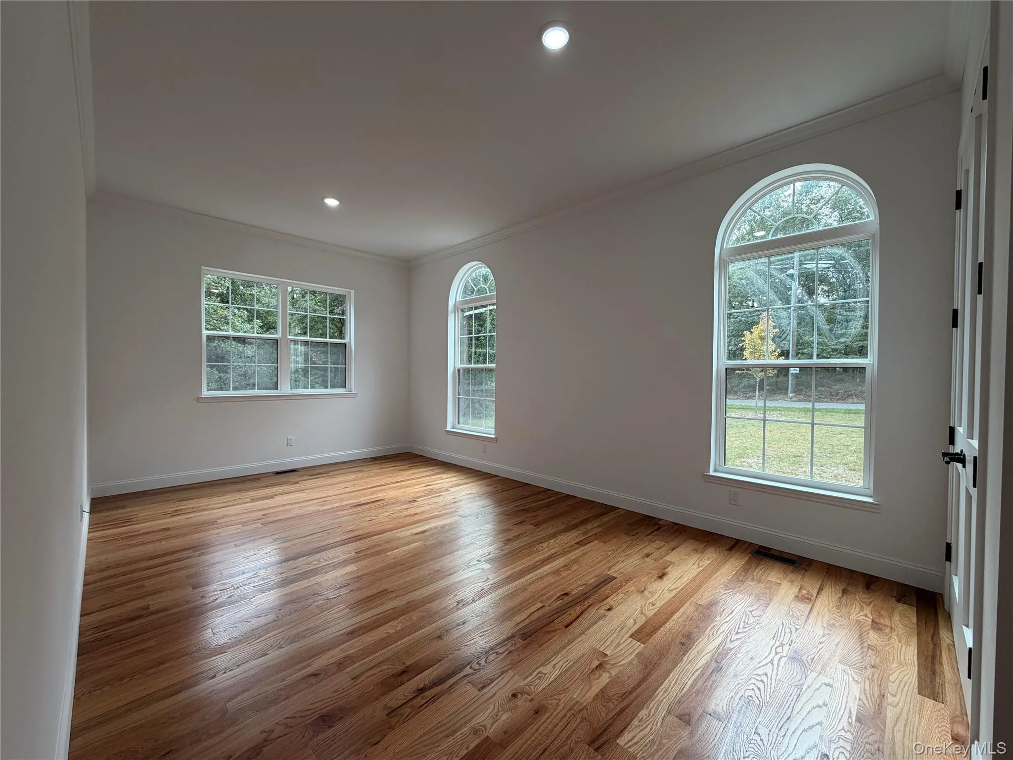 Wood-finish flooring with white baseboards Wood-finish flooring with white baseboards