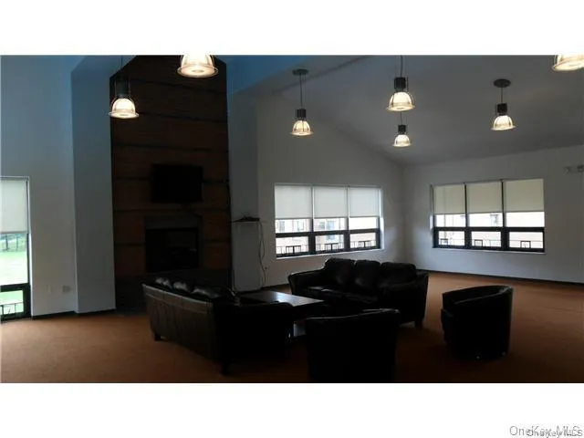 Clubhouse featuring a large open room with fireplace, large screen TV, couches, ping pong, pool table, etc - and a kitchen - perfect for hanging out or renting for a private party Clubhouse featuring a large open room with fireplace, large screen TV, couches, ping pong, pool table, etc - and a kitchen - perfect for hanging out or renting for a private party