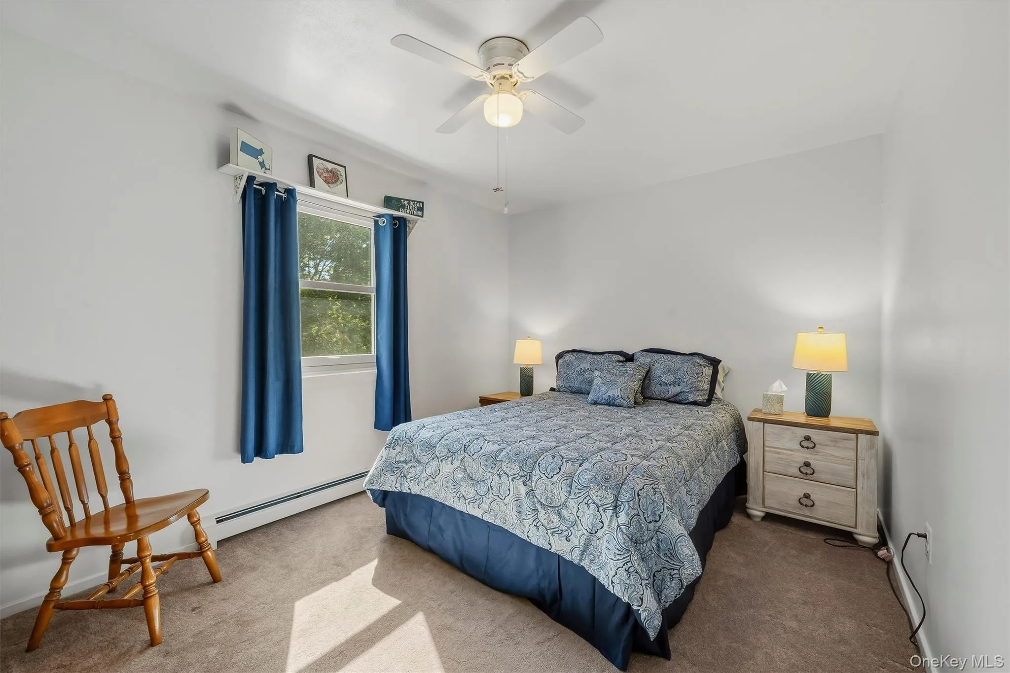Recessed window with white trim, wall-to-wall carpeting, and a ceiling fan with integrated lighting Recessed window with white trim, wall-to-wall carpeting, and a ceiling fan with integrated lighting