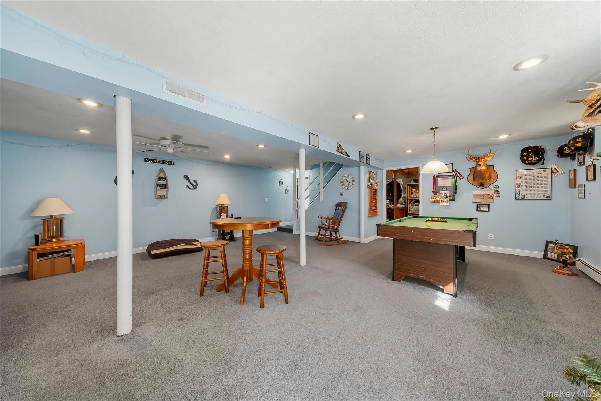 Finished lower level with recessed lighting, carpet flooring, and a ceiling fan Finished lower level with recessed lighting, carpet flooring, and a ceiling fan