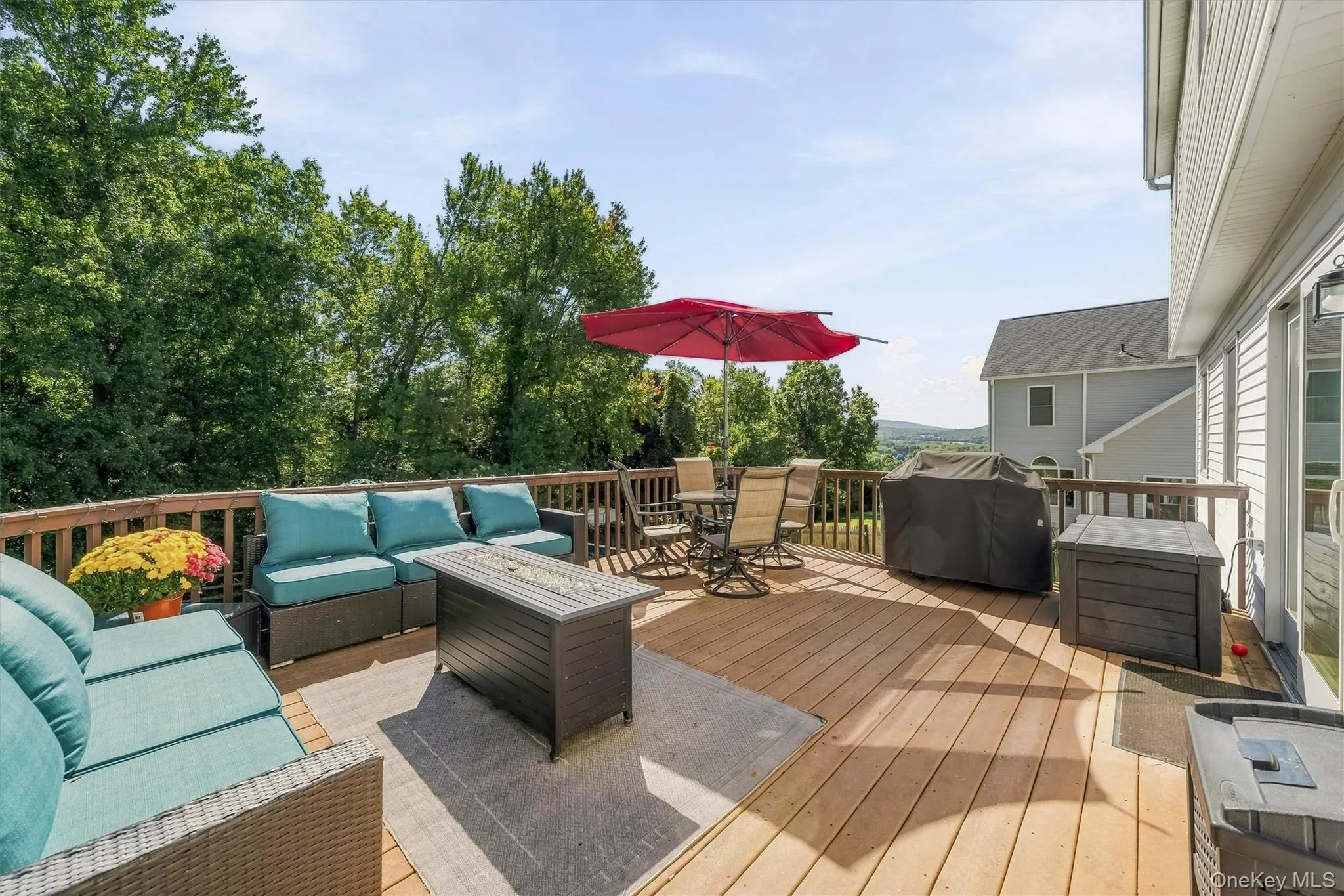 Spacious outdoor deck with wood railing, offering expansive open-air living Spacious outdoor deck with wood railing, offering expansive open-air living