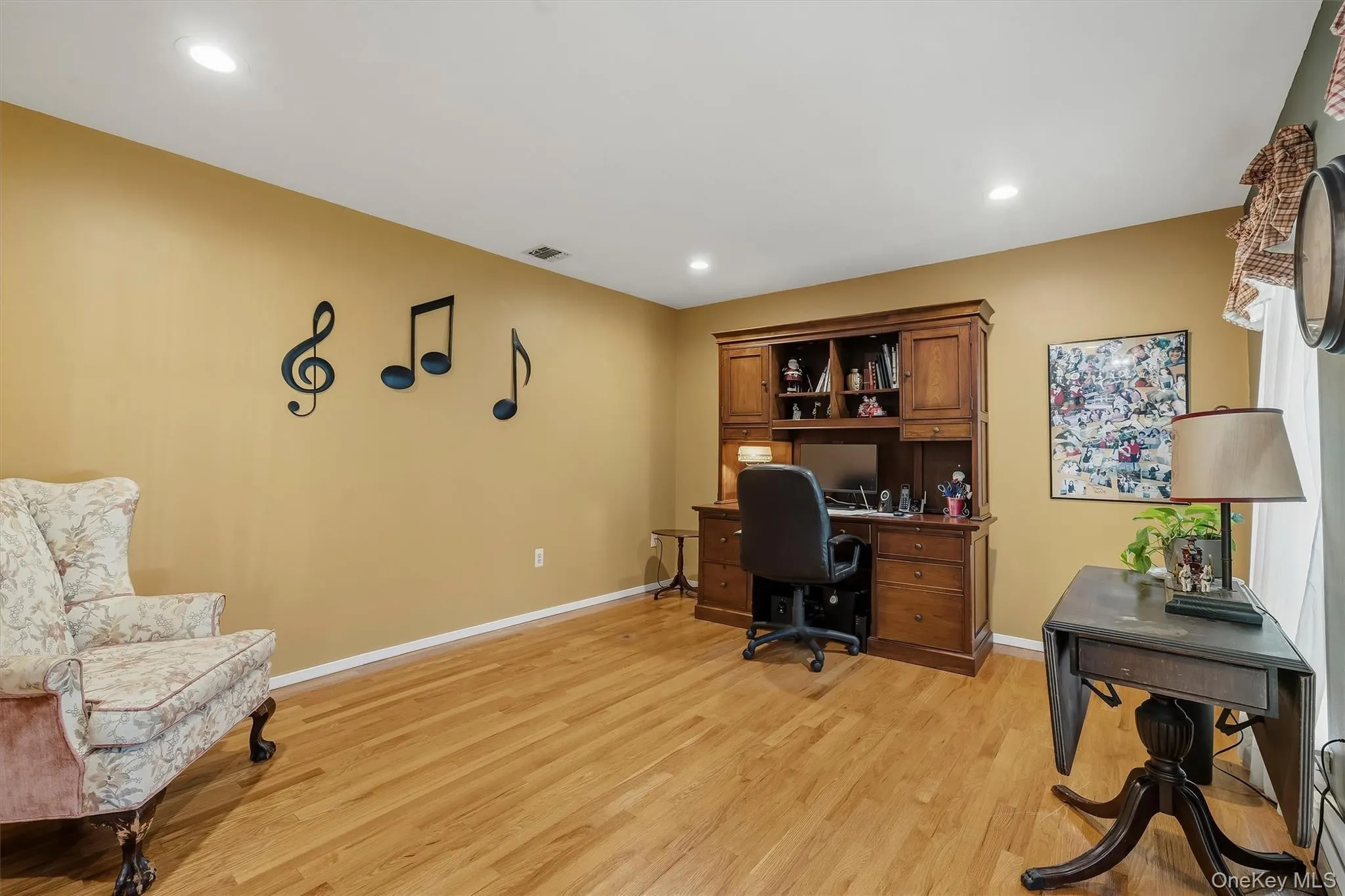 Recessed ceiling lighting, wood-finish flooring, and a window with natural light Recessed ceiling lighting, wood-finish flooring, and a window with natural light
