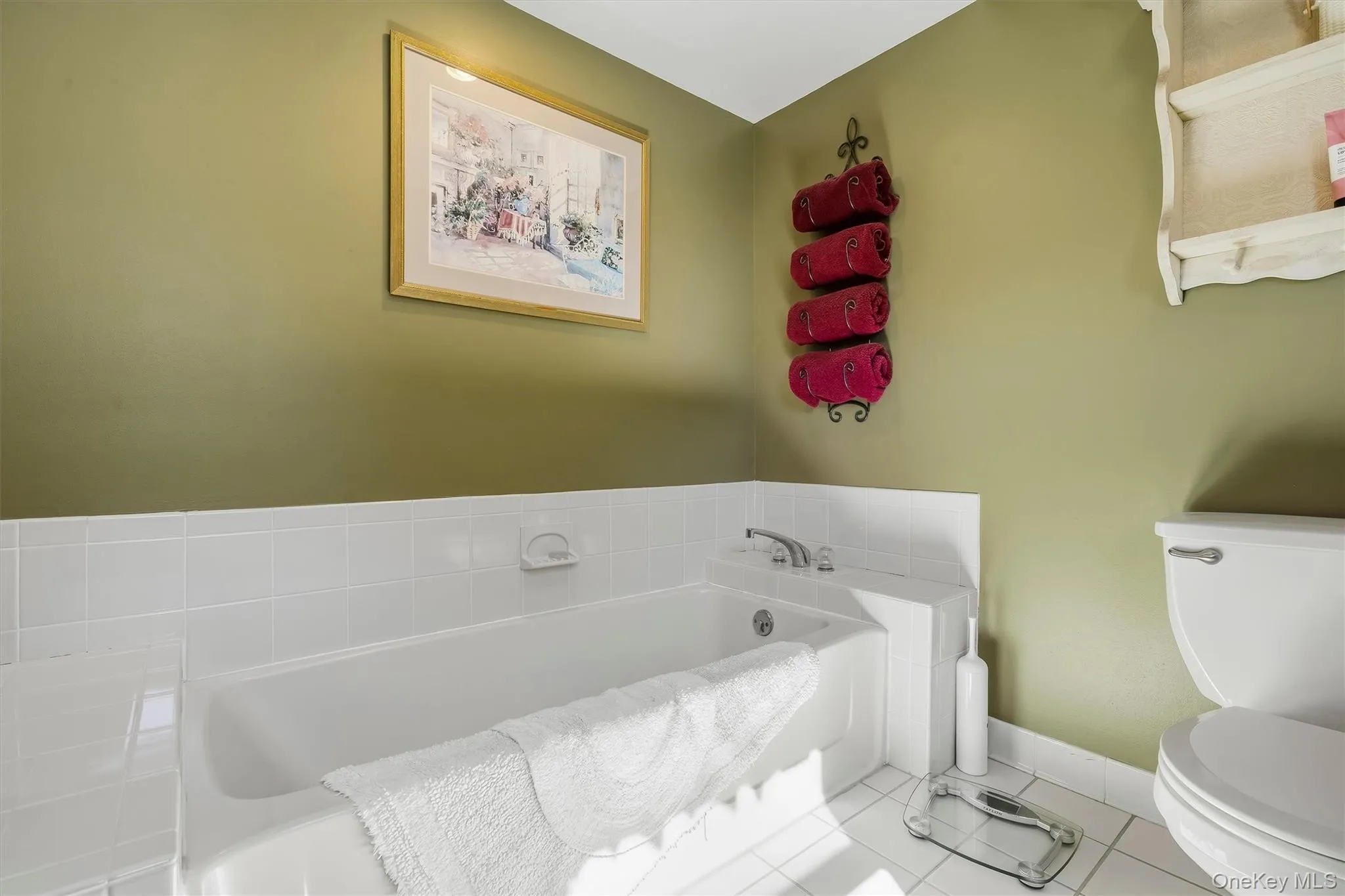 White tile flooring and bathtub surround White tile flooring and bathtub surround