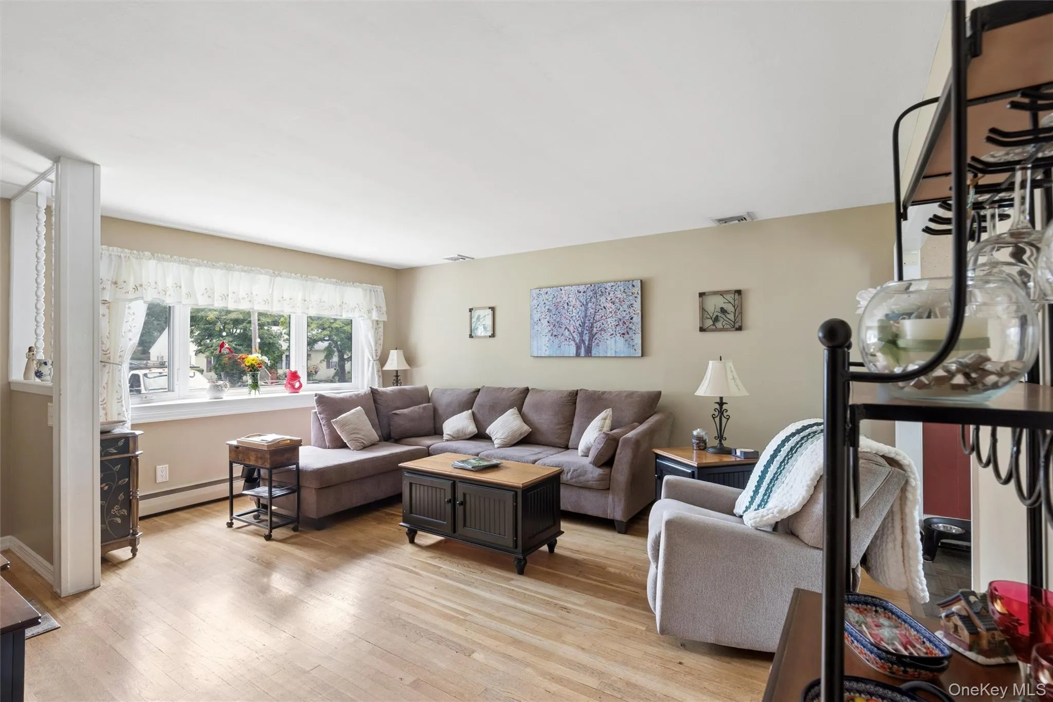 Sunlit Living Room with Bay Window and wood floors Sunlit Living Room with Bay Window and wood floors