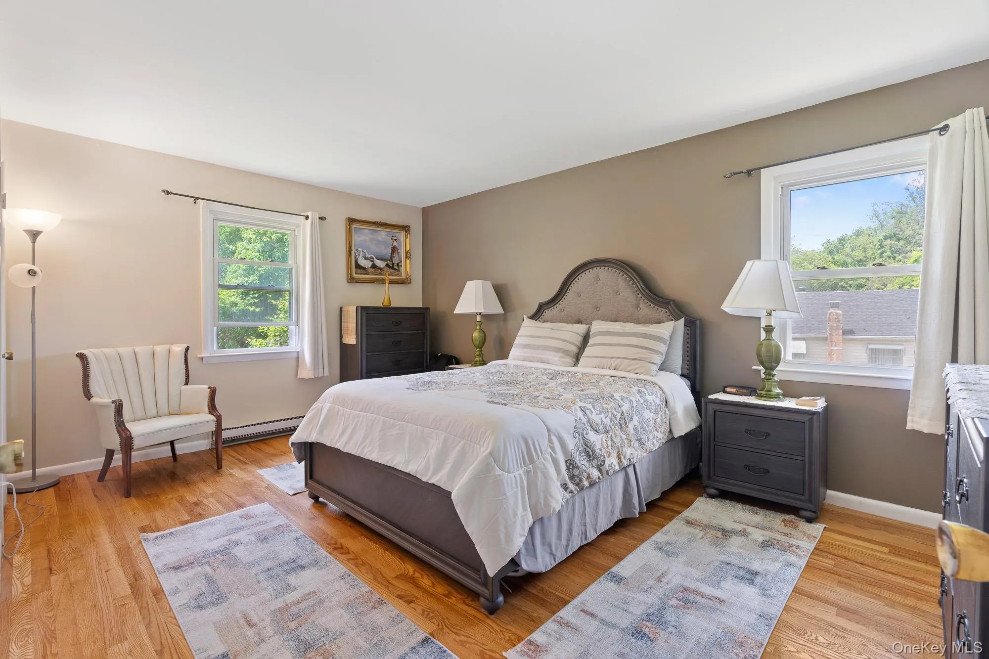 Bedroom with light wood-type flooring and baseboards Bedroom with light wood-type flooring and baseboards