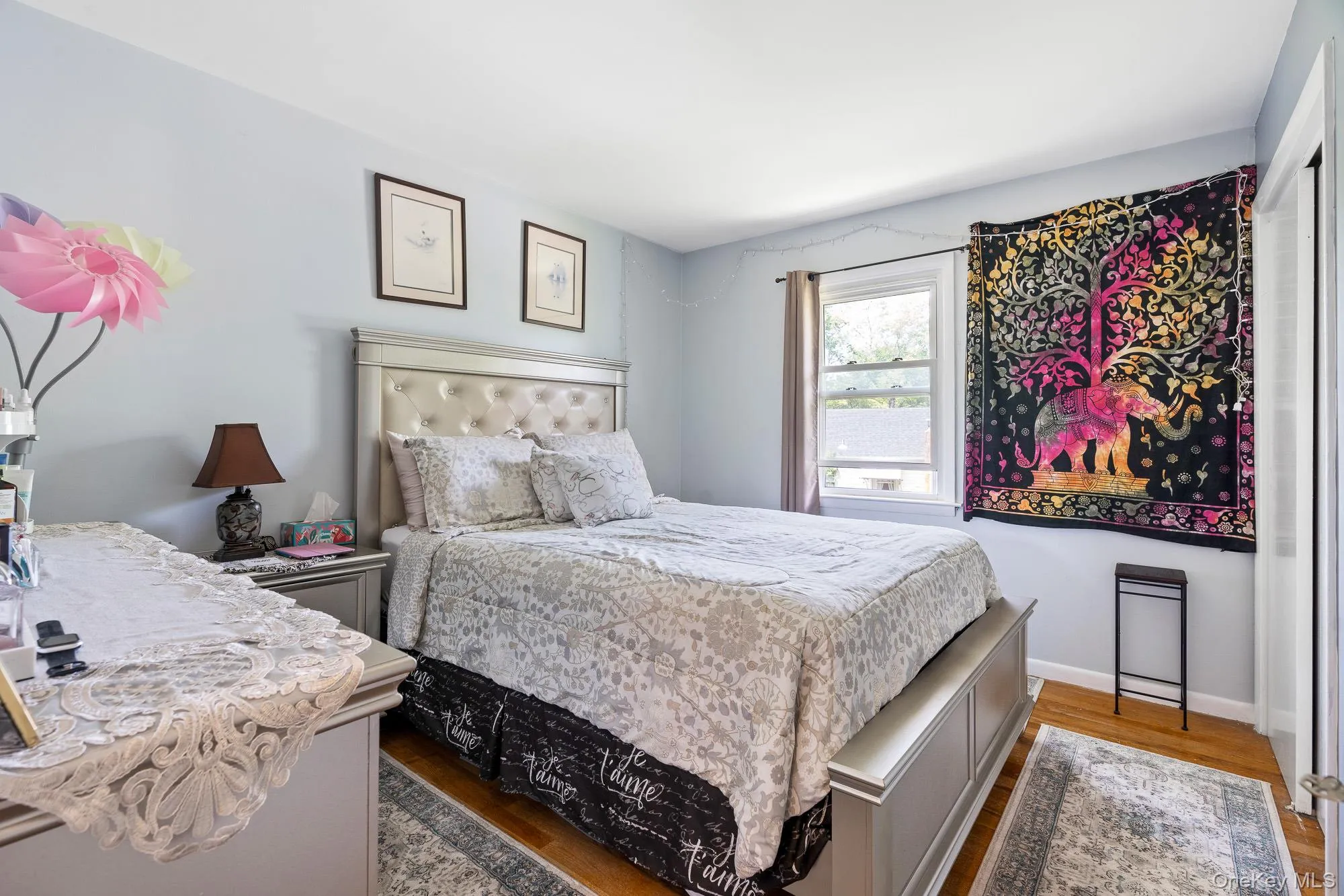 Bedroom featuring wood finished floors and baseboards Bedroom featuring wood finished floors and baseboards