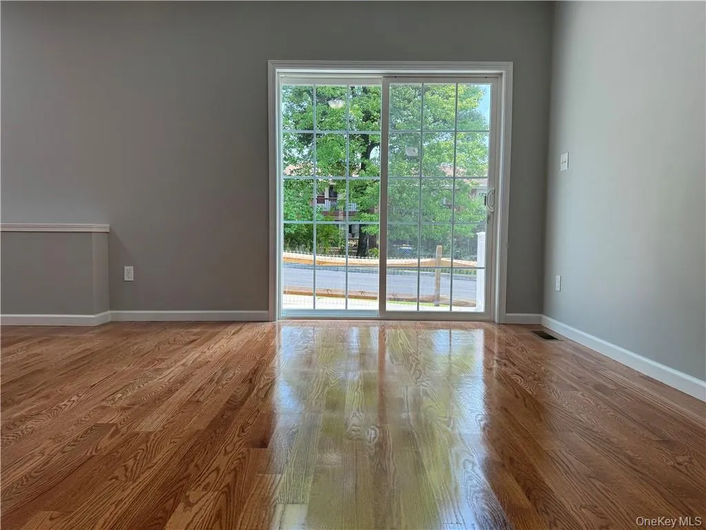 Empty room with hardwood / wood-style flooring Empty room with hardwood / wood-style flooring