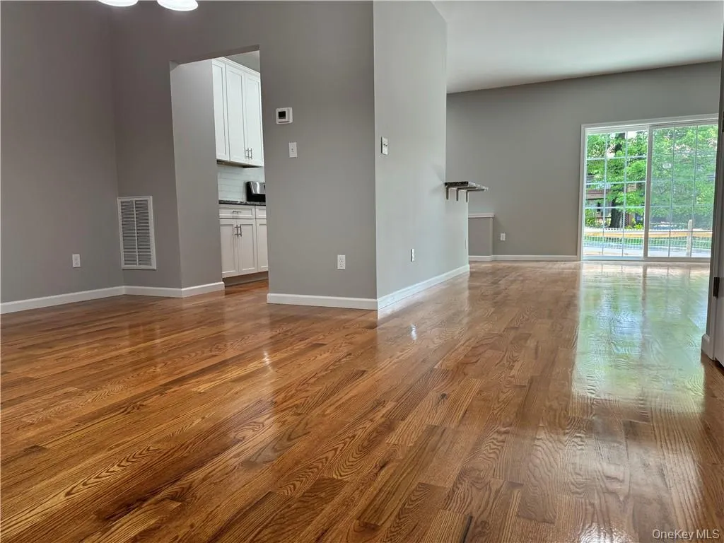Unfurnished room with hardwood / wood-style flooring Unfurnished room with hardwood / wood-style flooring