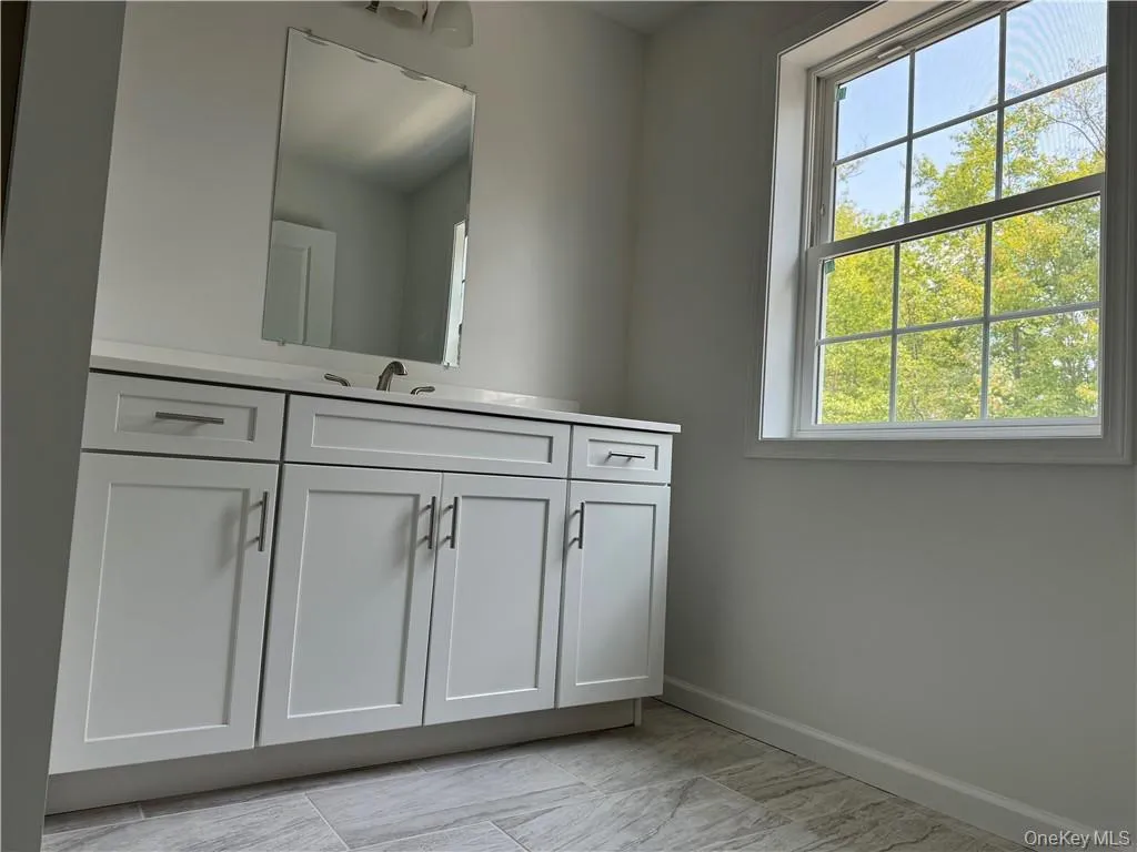 Bathroom featuring tile patterned floors and vanity Bathroom featuring tile patterned floors and vanity