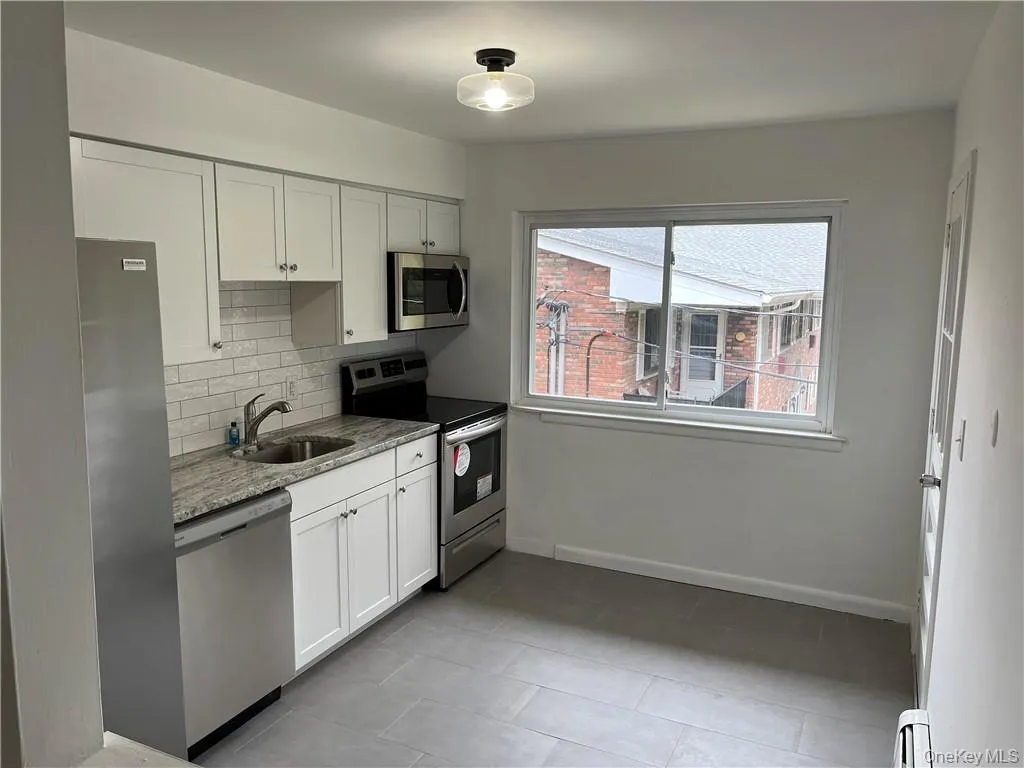 White Cabinetry, stainless appliances and granite countertop. White Cabinetry, stainless appliances and granite countertop.