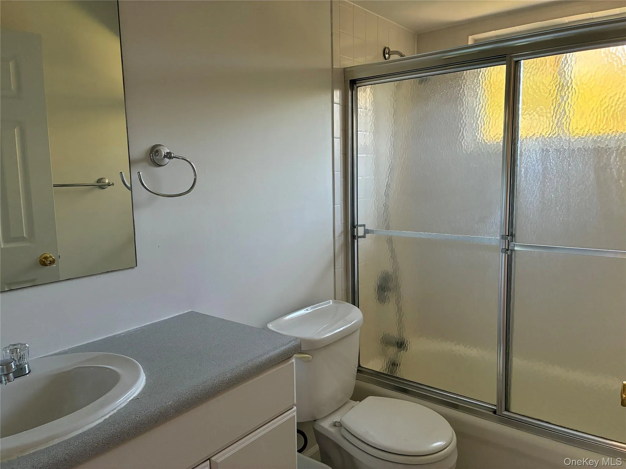 Full bathroom featuring a vanity with integrated sink, chrome faucet, and mirrored medicine cabinet Full bathroom featuring a vanity with integrated sink, chrome faucet, and mirrored medicine cabinet