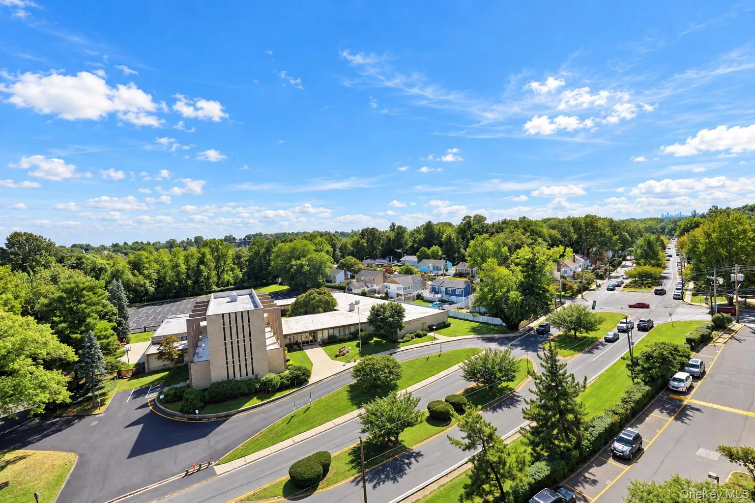 Property with expansive paved parking areas and mature landscaping Property with expansive paved parking areas and mature landscaping