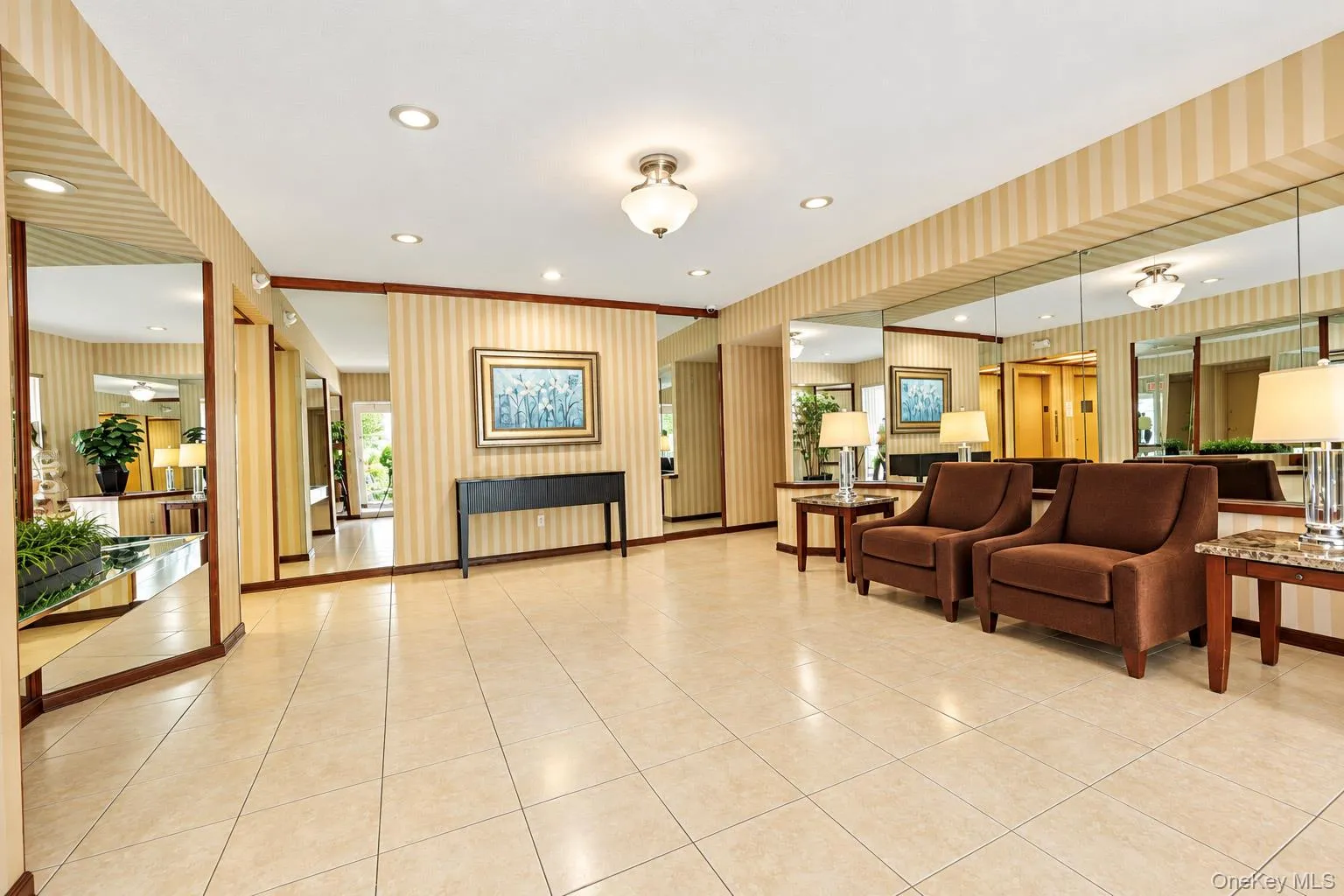 Recessed lighting, ceiling-mounted light fixture, tile flooring, wall-to-wall mirrors, and striped wall covering Recessed lighting, ceiling-mounted light fixture, tile flooring, wall-to-wall mirrors, and striped wall covering