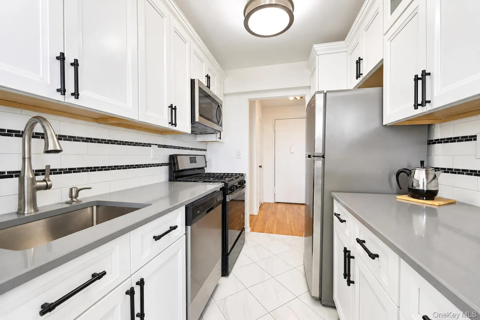 White shaker cabinetry with matte black hardware White shaker cabinetry with matte black hardware