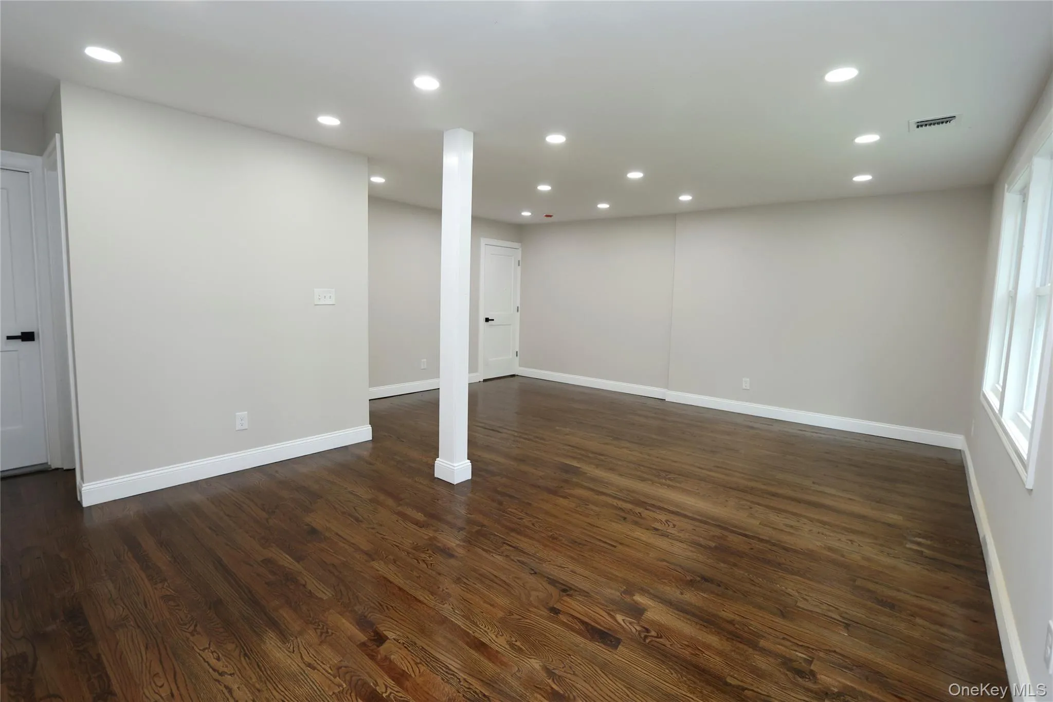 Recessed lighting, wood-finish flooring, light-colored walls, white trim, and multiple windows Recessed lighting, wood-finish flooring, light-colored walls, white trim, and multiple windows