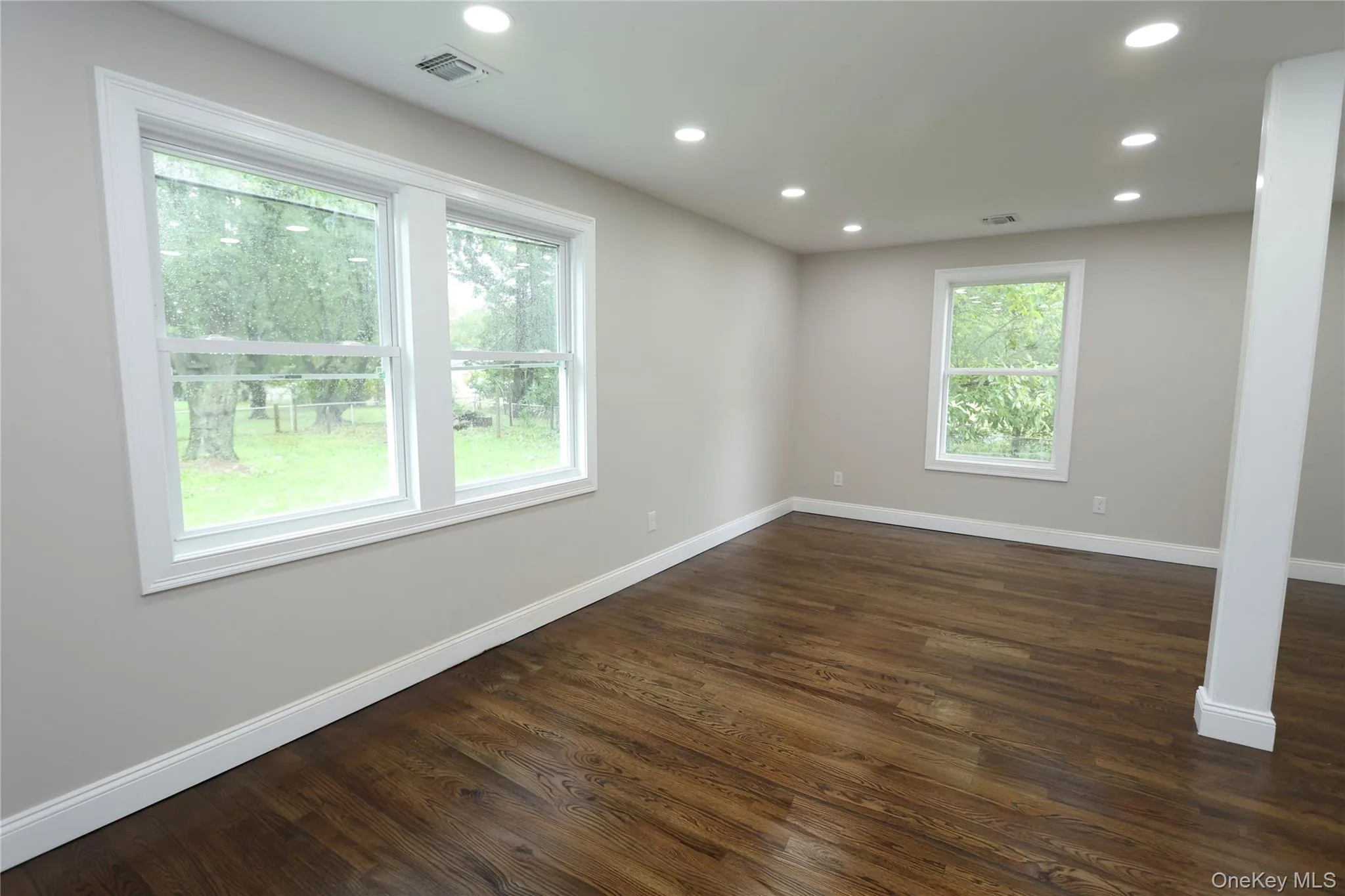 Hardwood-finish flooring, recessed lighting, multiple windows, and a neutral wall color Hardwood-finish flooring, recessed lighting, multiple windows, and a neutral wall color