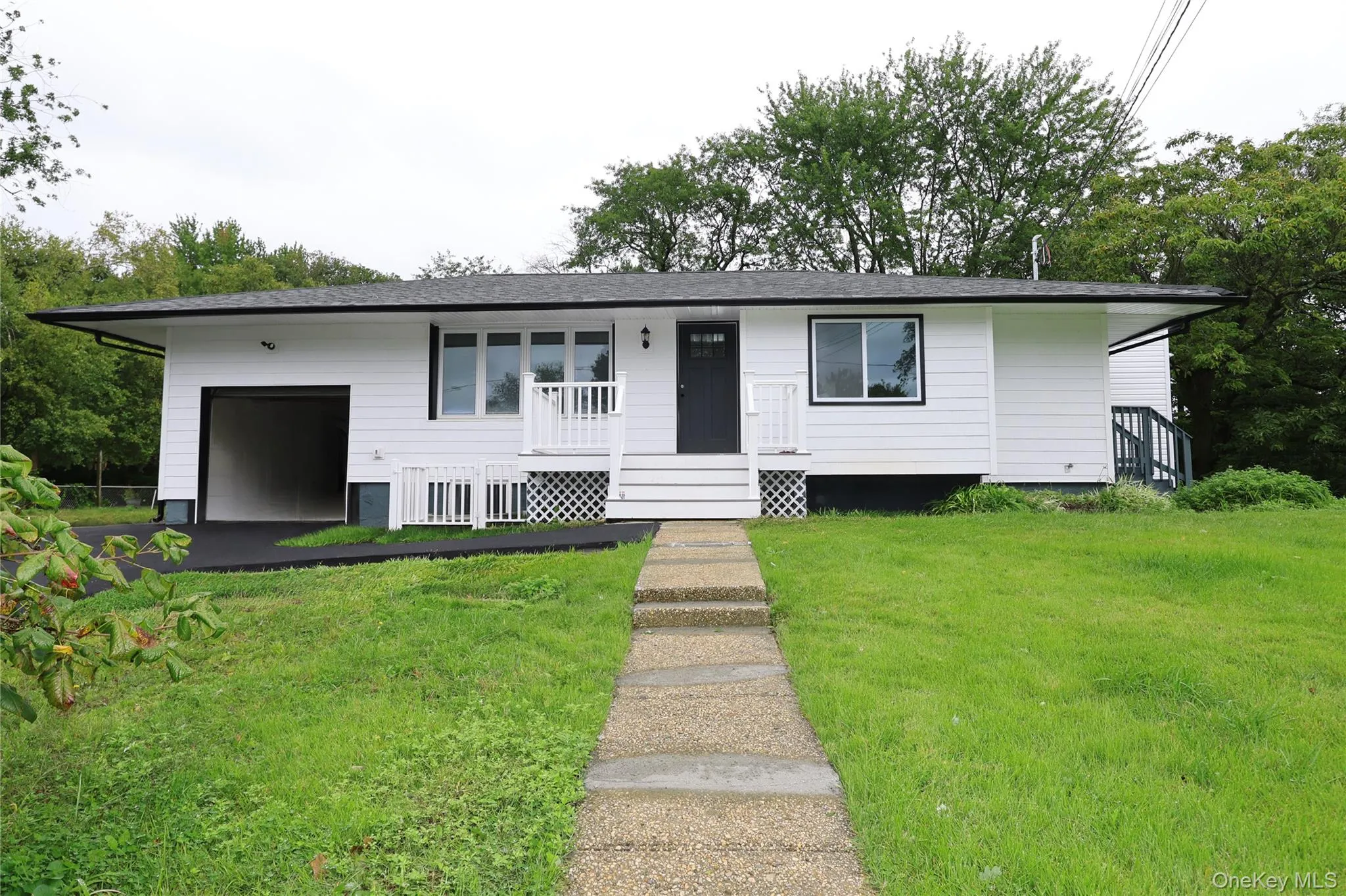 White exterior siding with dark trim accents White exterior siding with dark trim accents