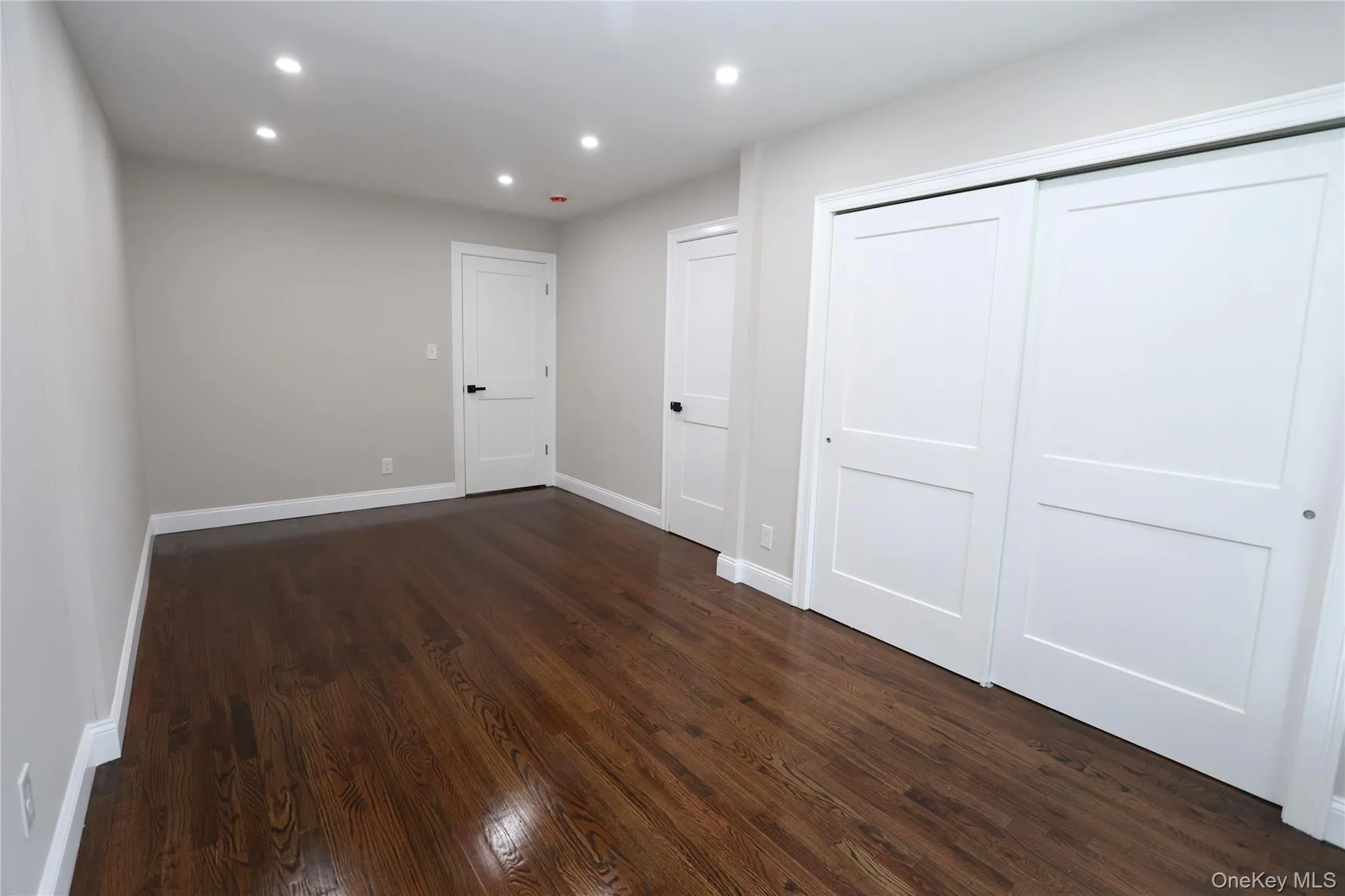 Recessed ceiling lighting, wood-finish flooring, two-panel interior doors, and sliding closet doors Recessed ceiling lighting, wood-finish flooring, two-panel interior doors, and sliding closet doors
