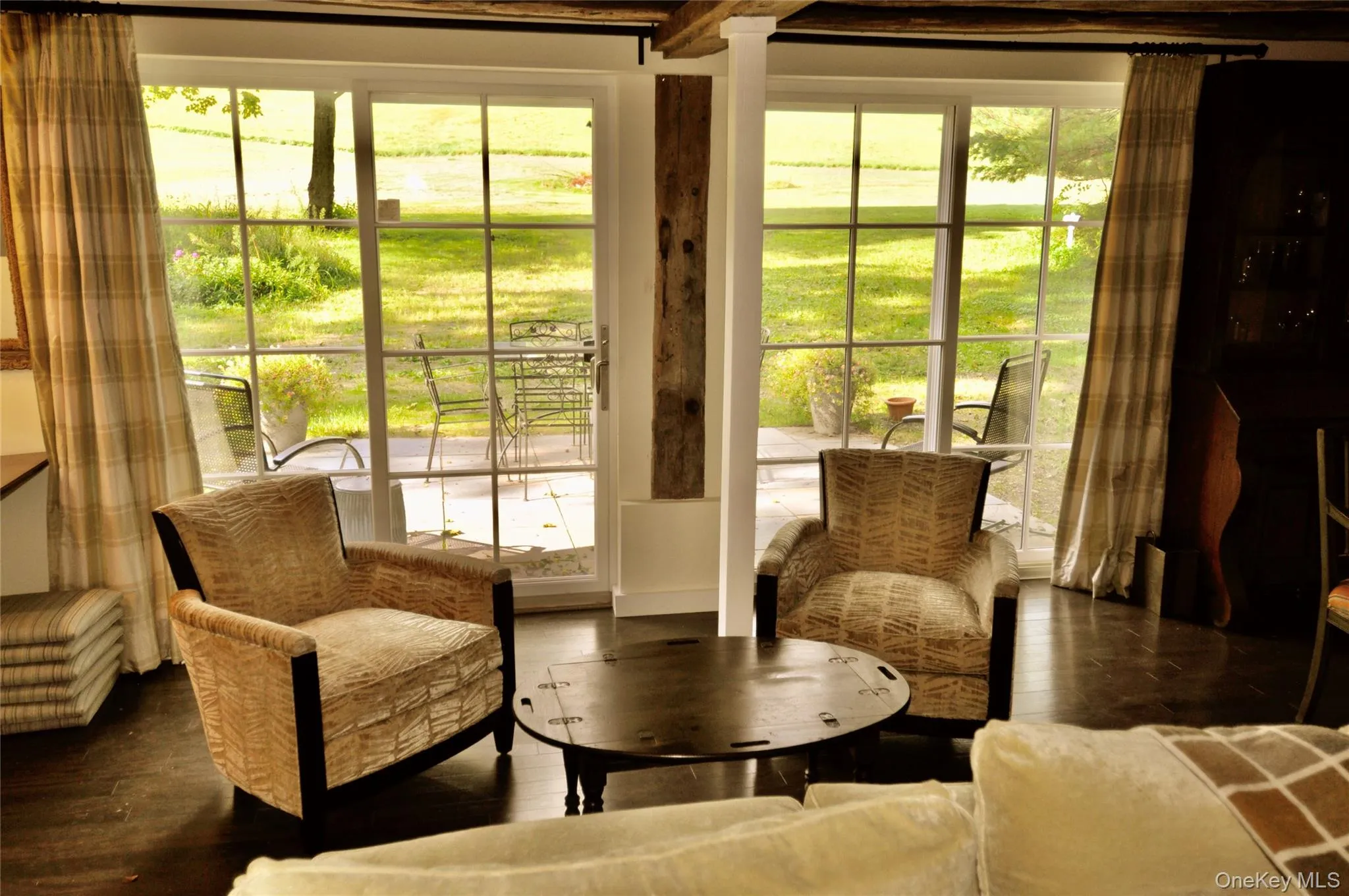Living area with plenty of natural light and dark wood-style flooring Living area with plenty of natural light and dark wood-style flooring