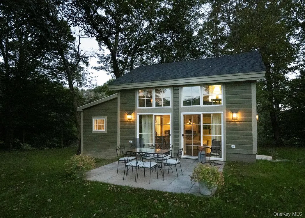 Back of property with a patio, a yard, and a shingled roof Back of property with a patio, a yard, and a shingled roof