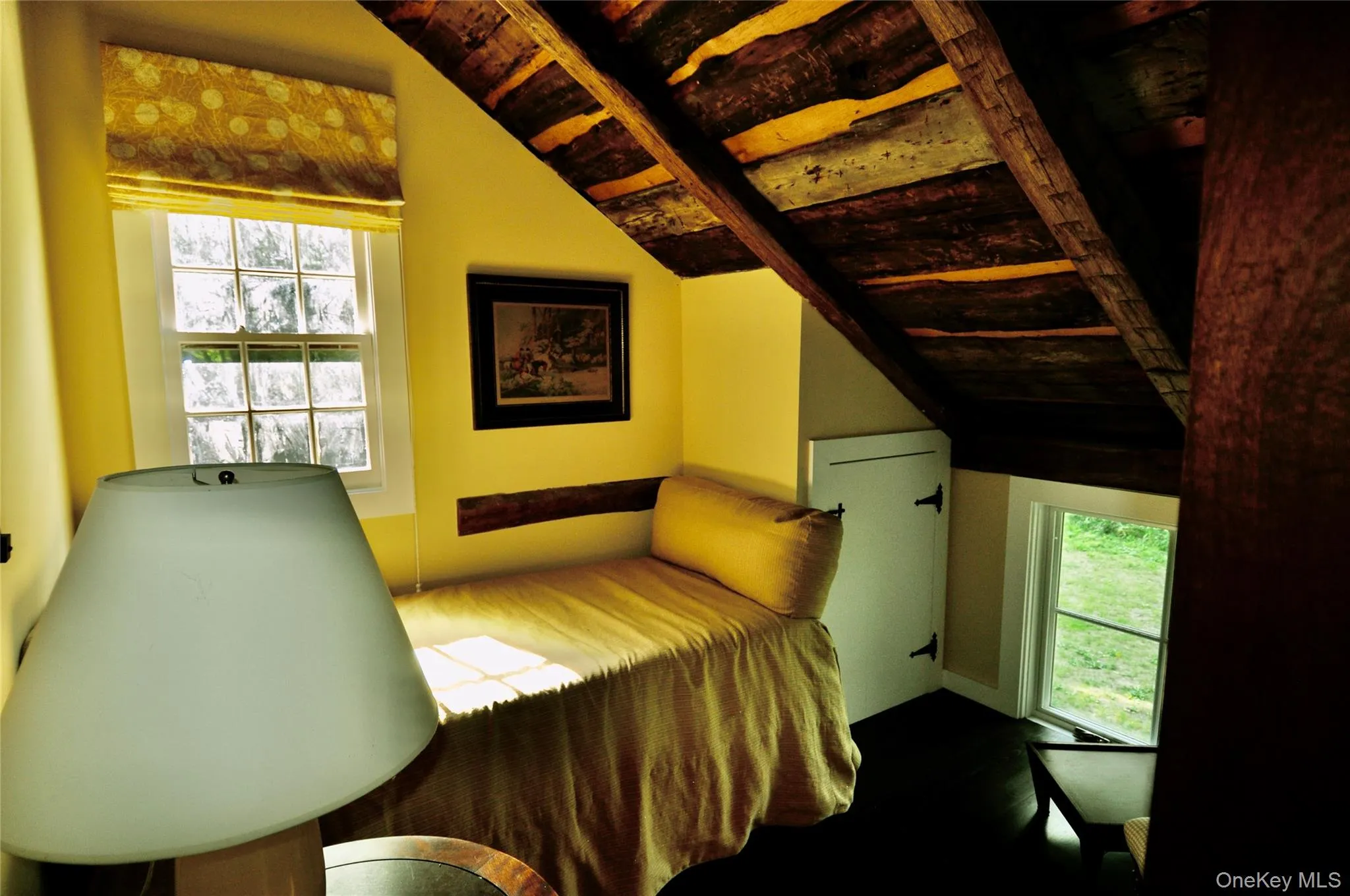 Bedroom featuring multiple windows and lofted ceiling Bedroom featuring multiple windows and lofted ceiling