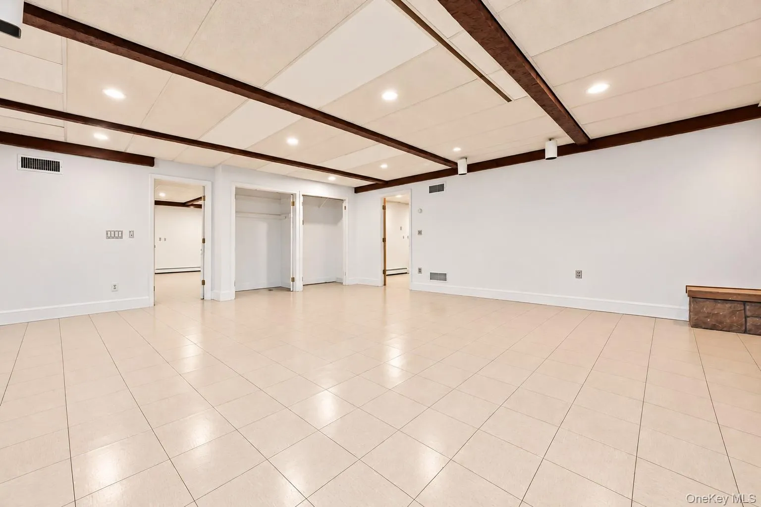 Lower level family room. Vinyl tile floor, large closets, door to large mudroom and garage. Lower level family room. Vinyl tile floor, large closets, door to large mudroom and garage.