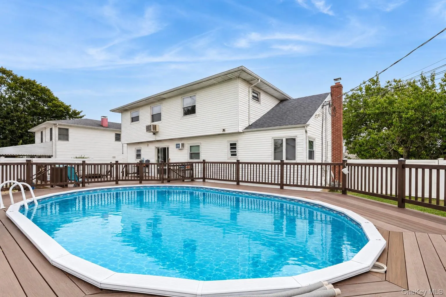Permitted partially inground pool with fence and trek decking surrounding (virtually enhanced) Permitted partially inground pool with fence and trek decking surrounding (virtually enhanced)